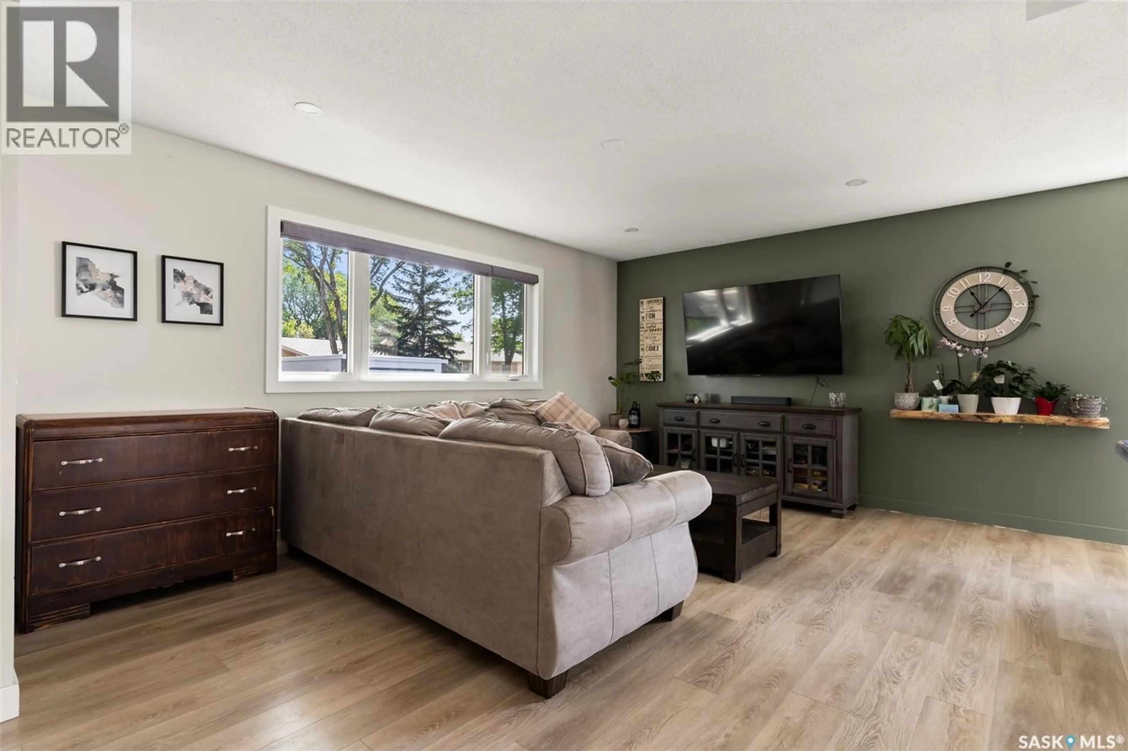 Living room with furniture, wood/laminate floor for 26 NORWOOD CRESCENT, Regina Saskatchewan S4R0A1