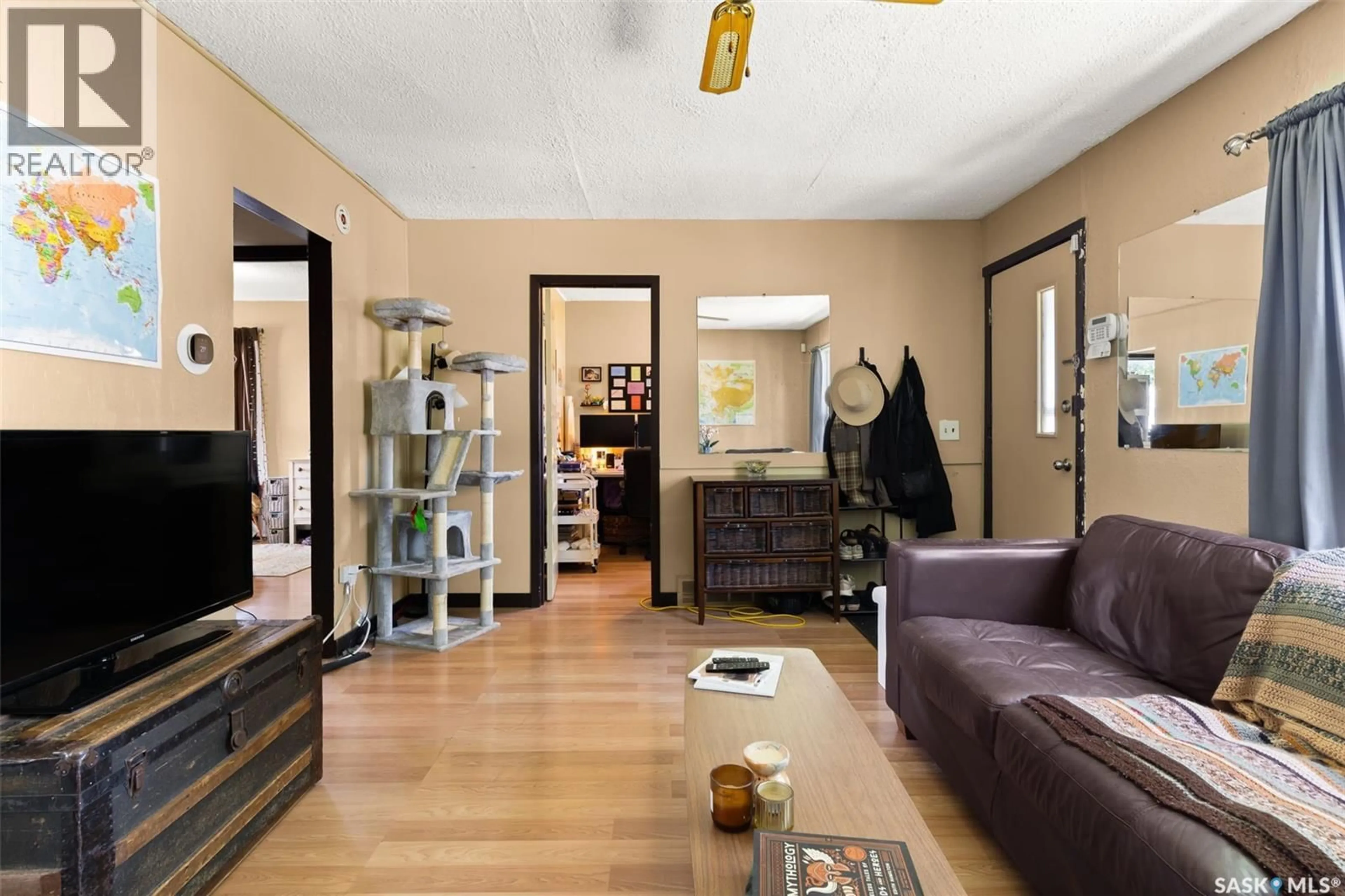 Living room with furniture, wood/laminate floor for 1649 GARNET STREET, Regina Saskatchewan S4T2Z1