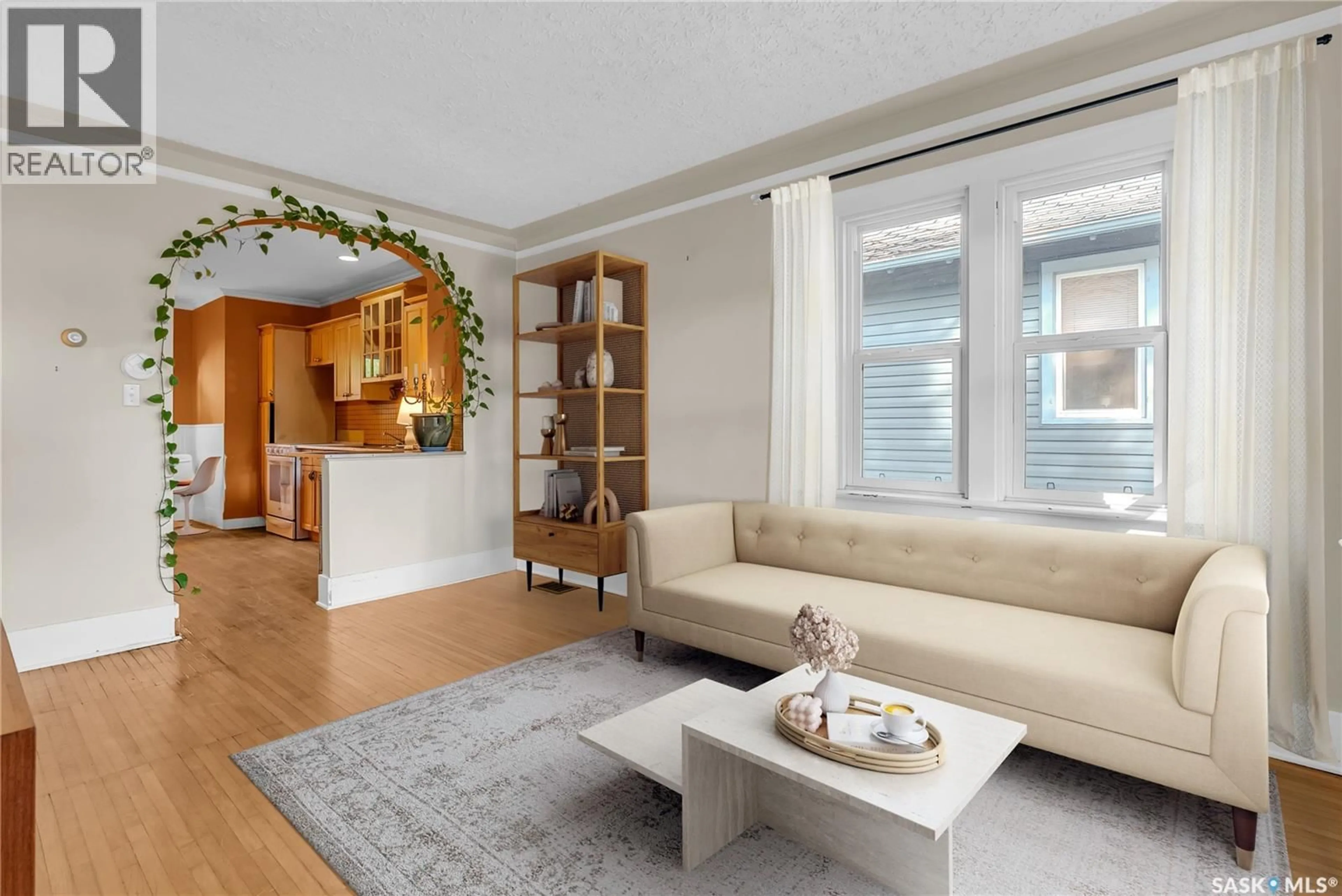 Living room with furniture, wood/laminate floor for 119 MAPLE STREET, Saskatoon Saskatchewan S7J0A2