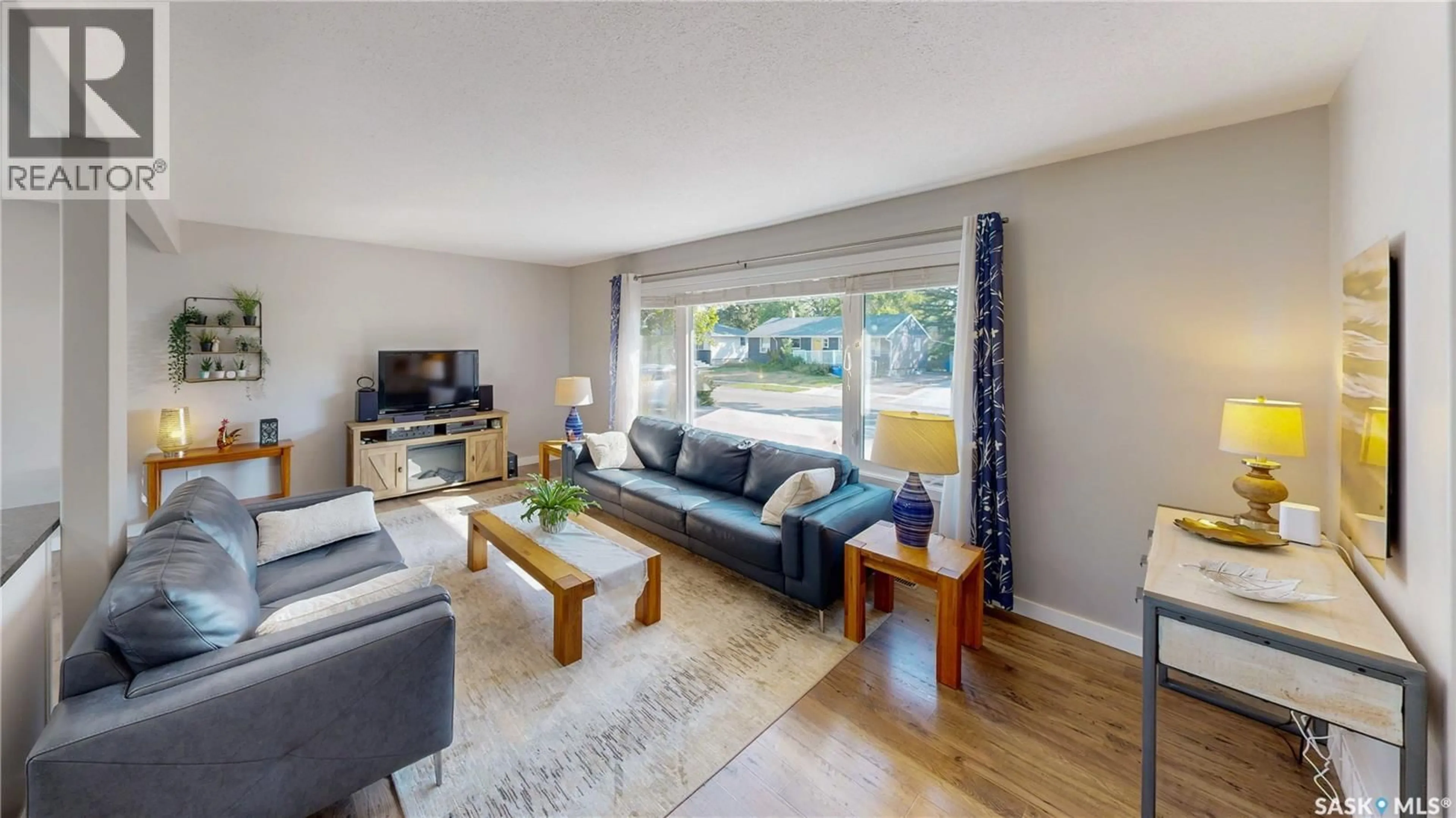 Living room with furniture, wood/laminate floor for 58 LAMONT CRESCENT, Regina Saskatchewan S4S4A4