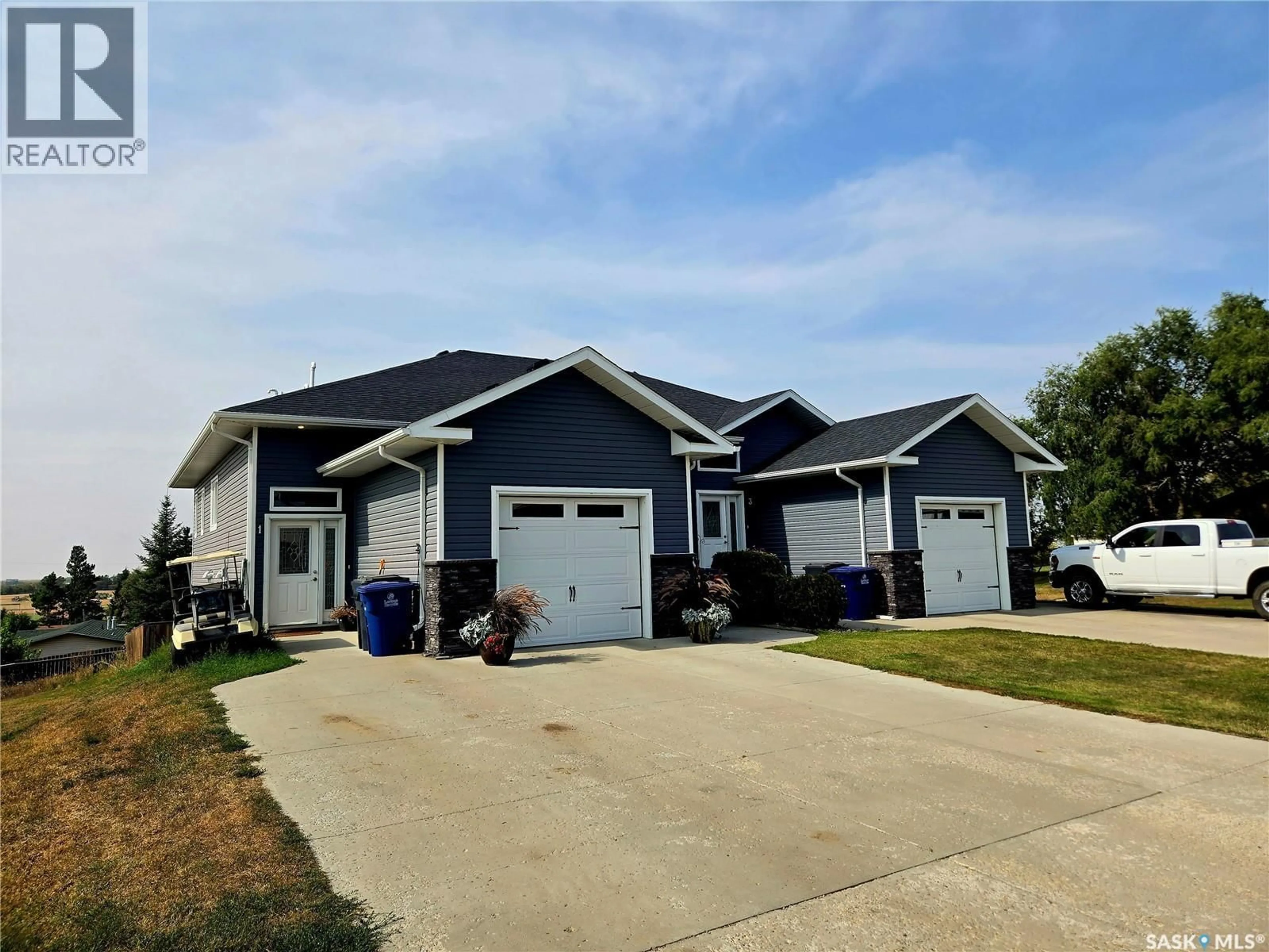 Home with vinyl exterior material, street for 1-4 316 3RD STREET, Delisle Saskatchewan S0L0P0