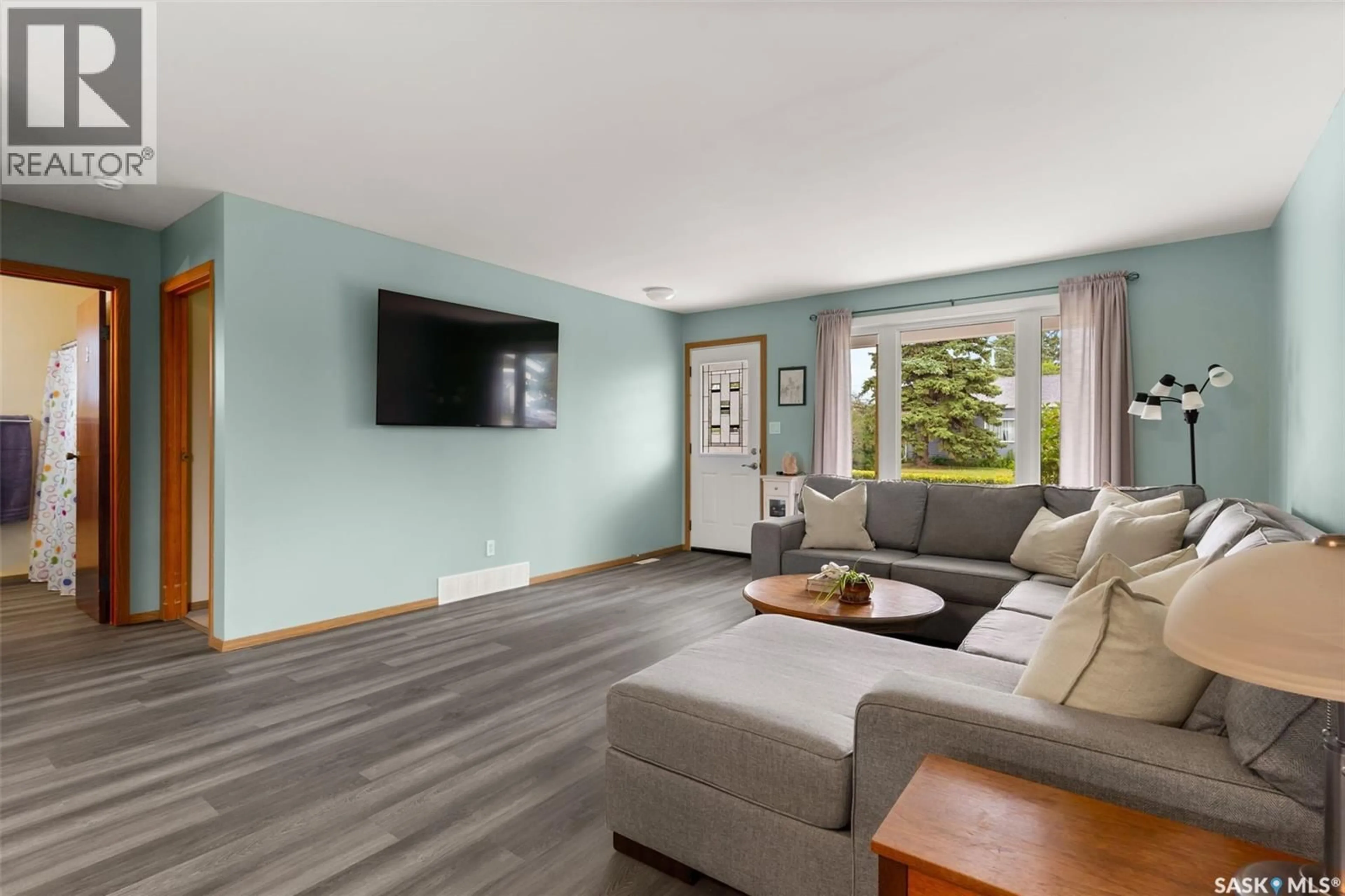 Living room with furniture, wood/laminate floor for 265 BROWNING STREET, Southey Saskatchewan S0G4P0