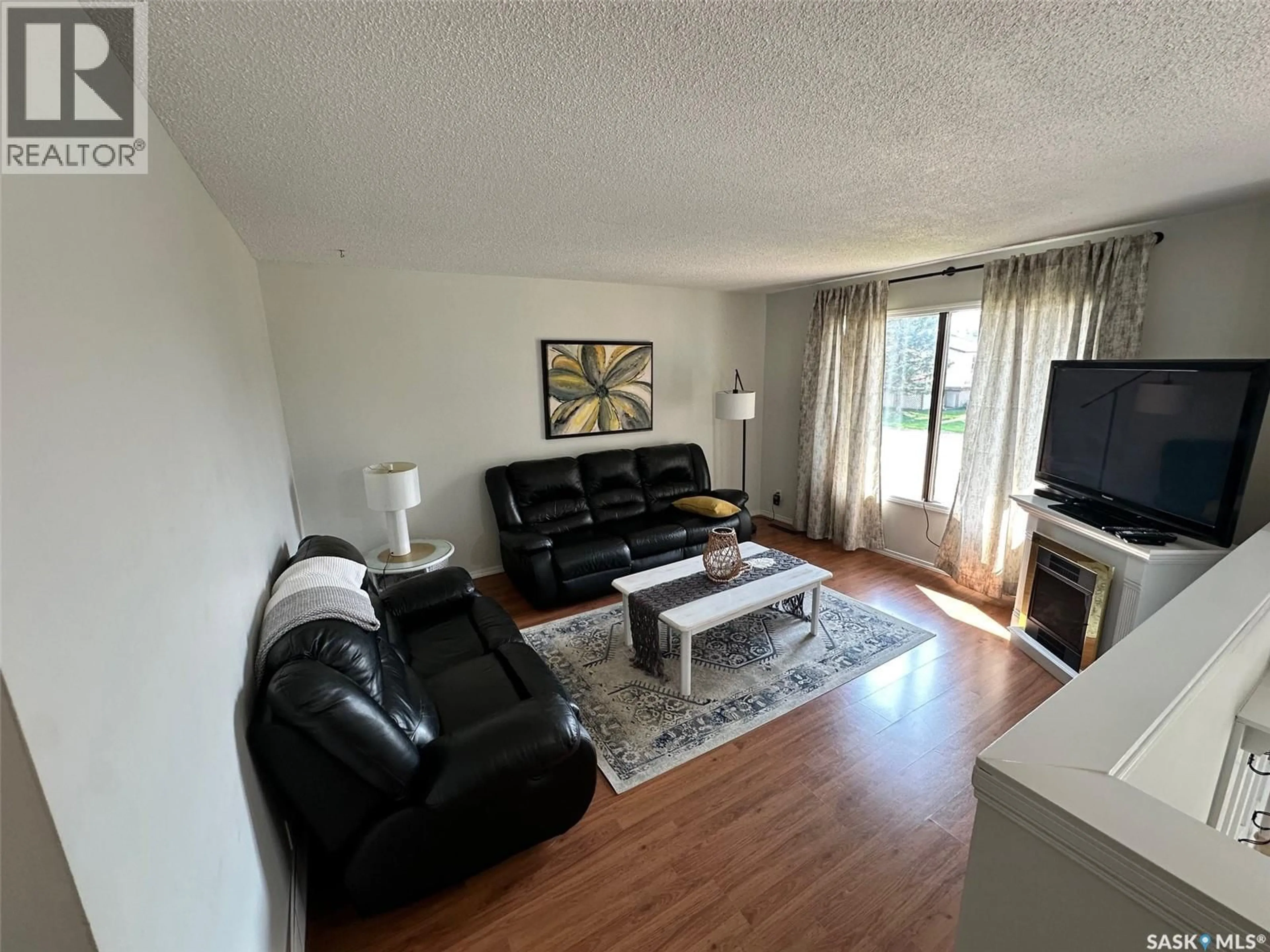Living room with furniture, wood/laminate floor for 534 MAIN STREET, Hudson Bay Saskatchewan S0E0Y0