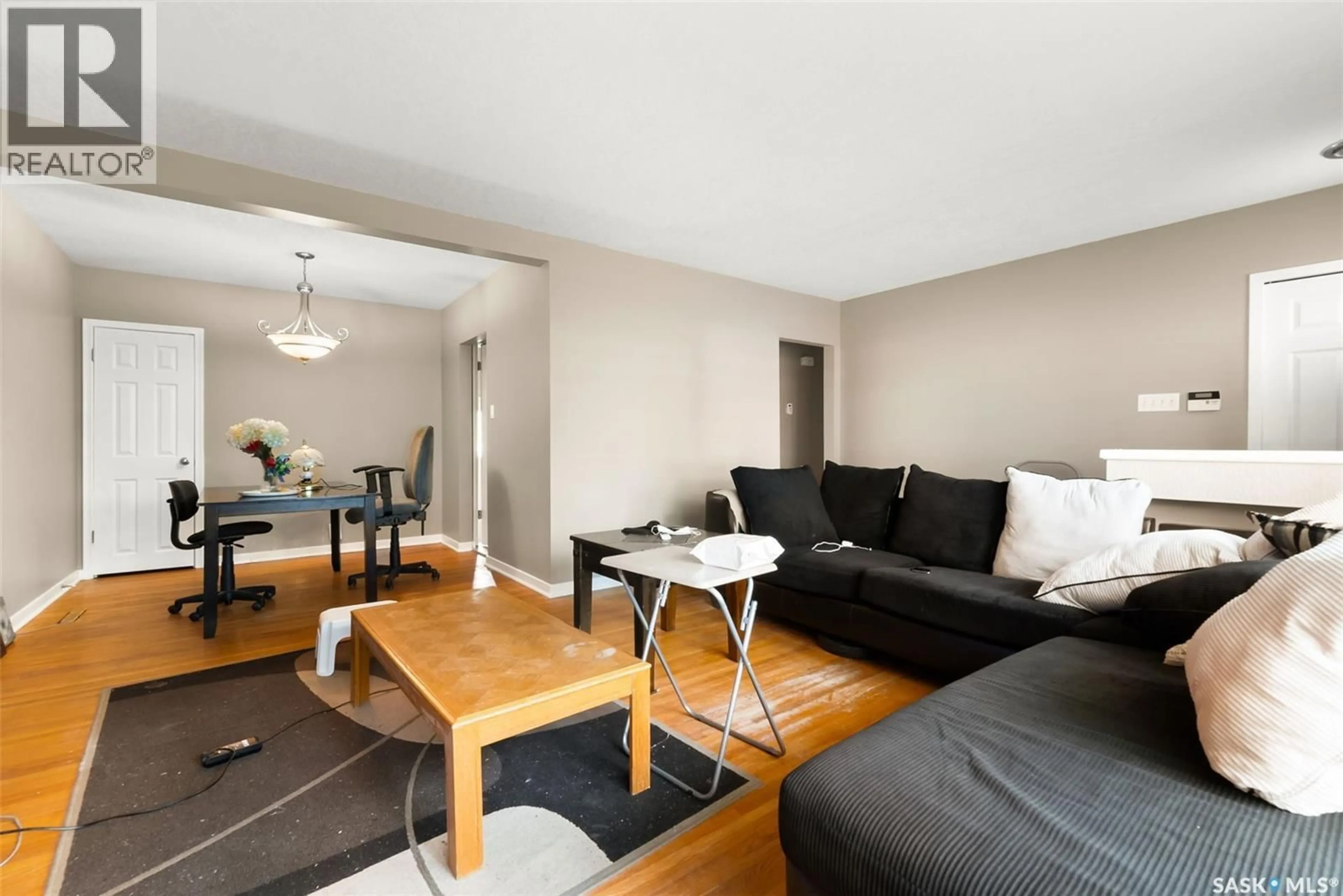 Living room with furniture, wood/laminate floor for 2213 GRANT ROAD, Regina Saskatchewan S4S5C9