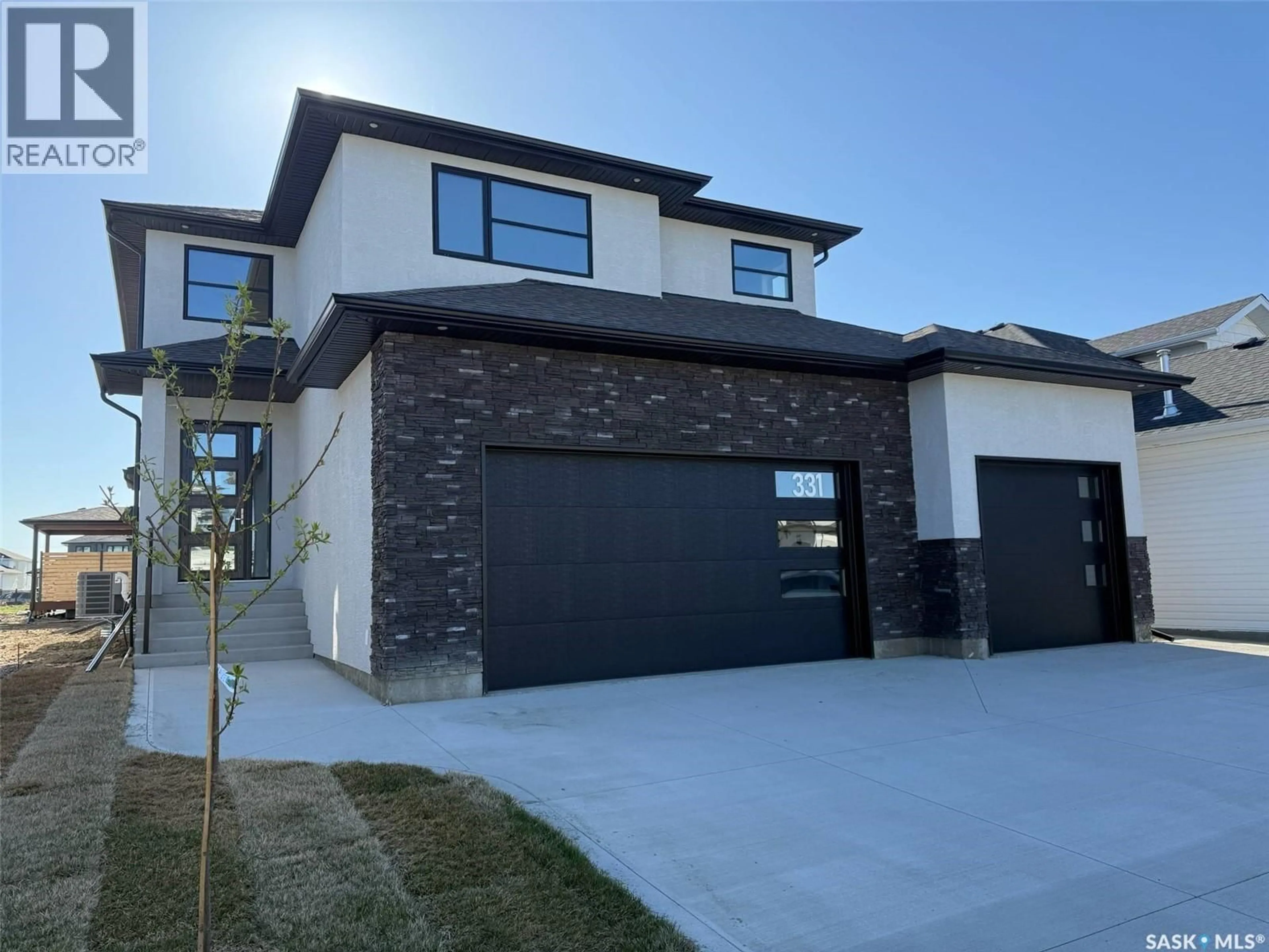 Home with brick exterior material, street for 331 WOOLF BAY, Saskatoon Saskatchewan S7W1E5