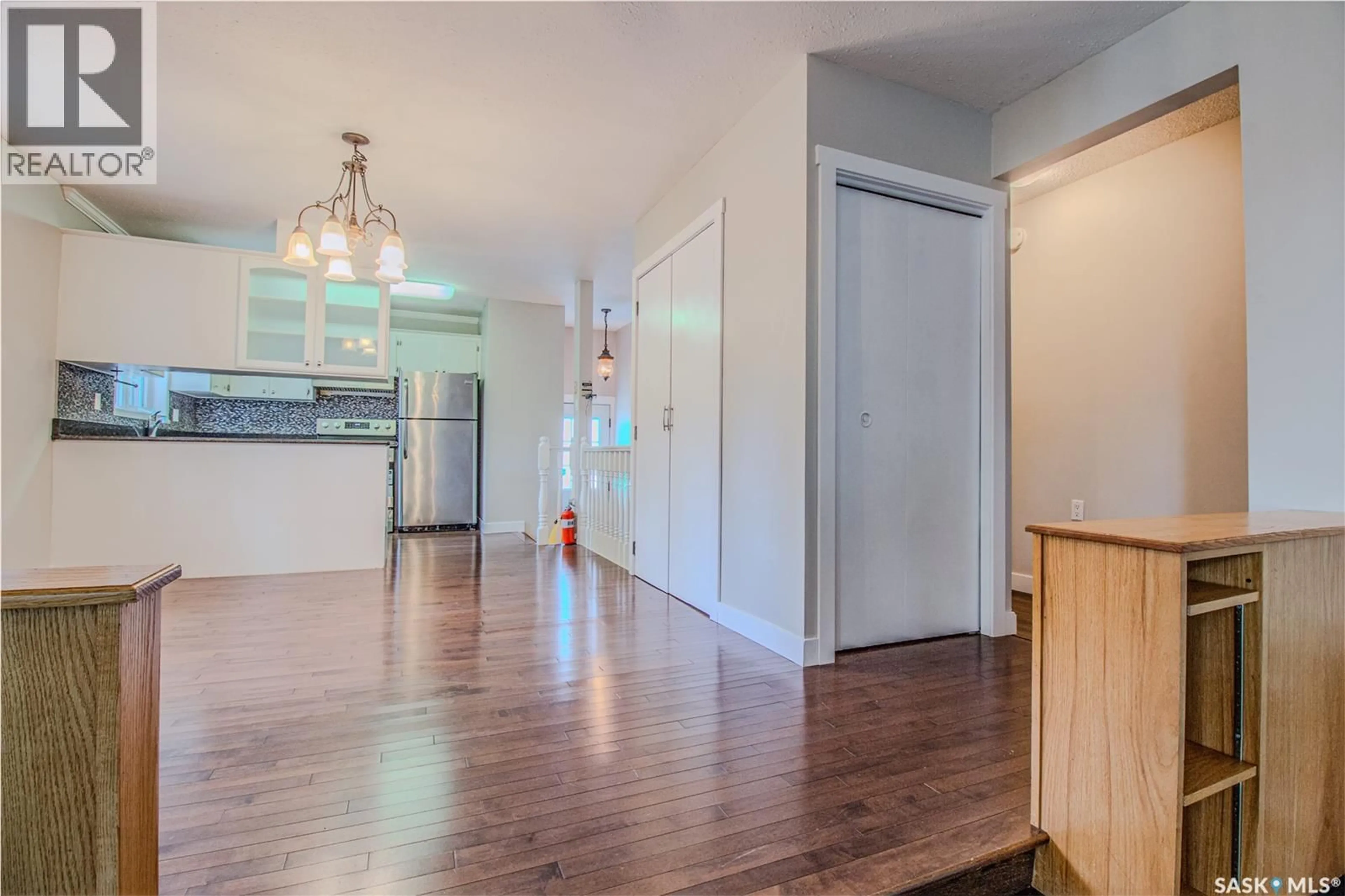 Open concept kitchen, wood/laminate floor for 61 SPARLING CRESCENT, Saskatoon Saskatchewan S7H3M1