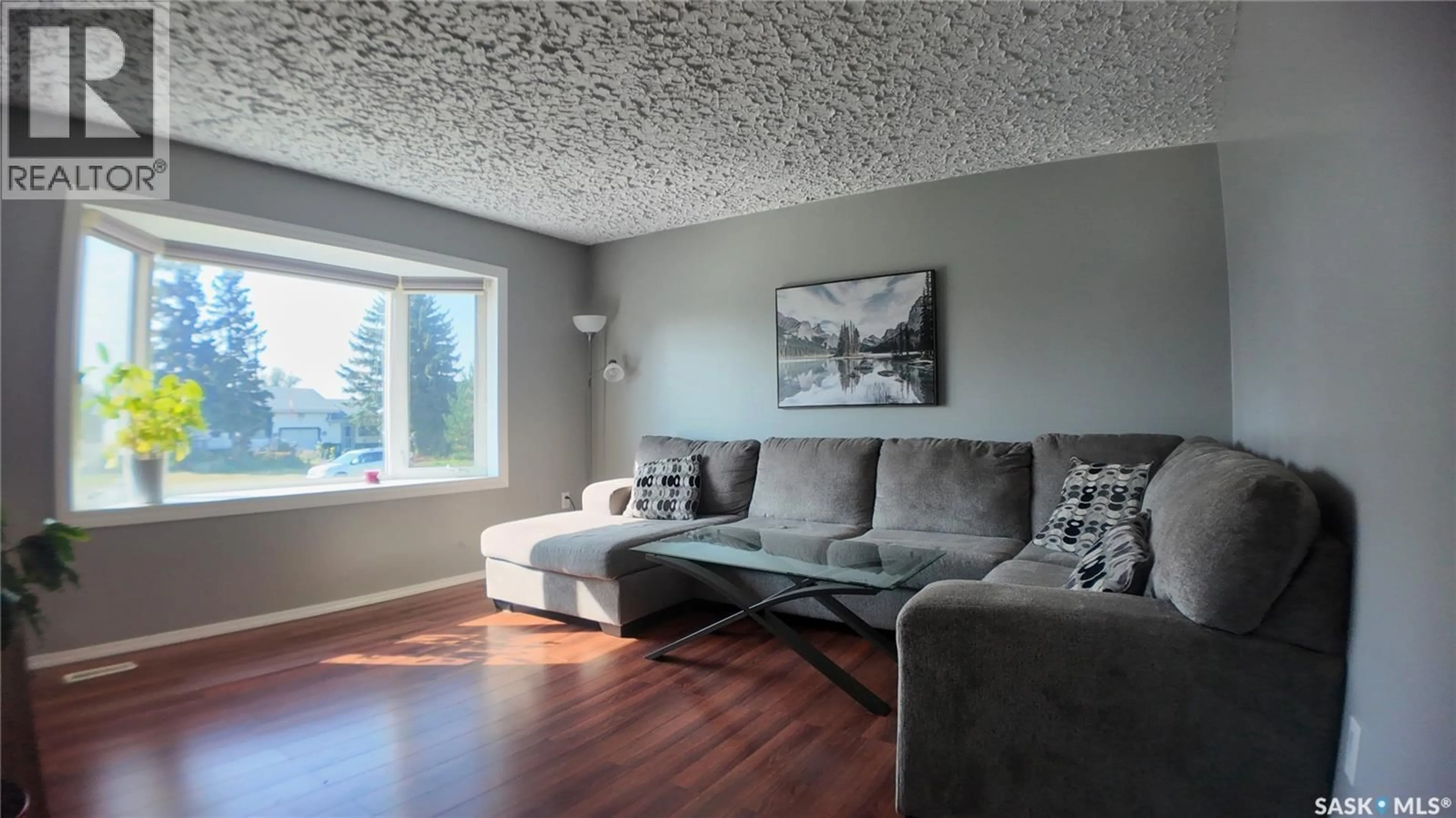 Living room with furniture, wood/laminate floor for 62 20TH STREET, Battleford Saskatchewan S0M0E0
