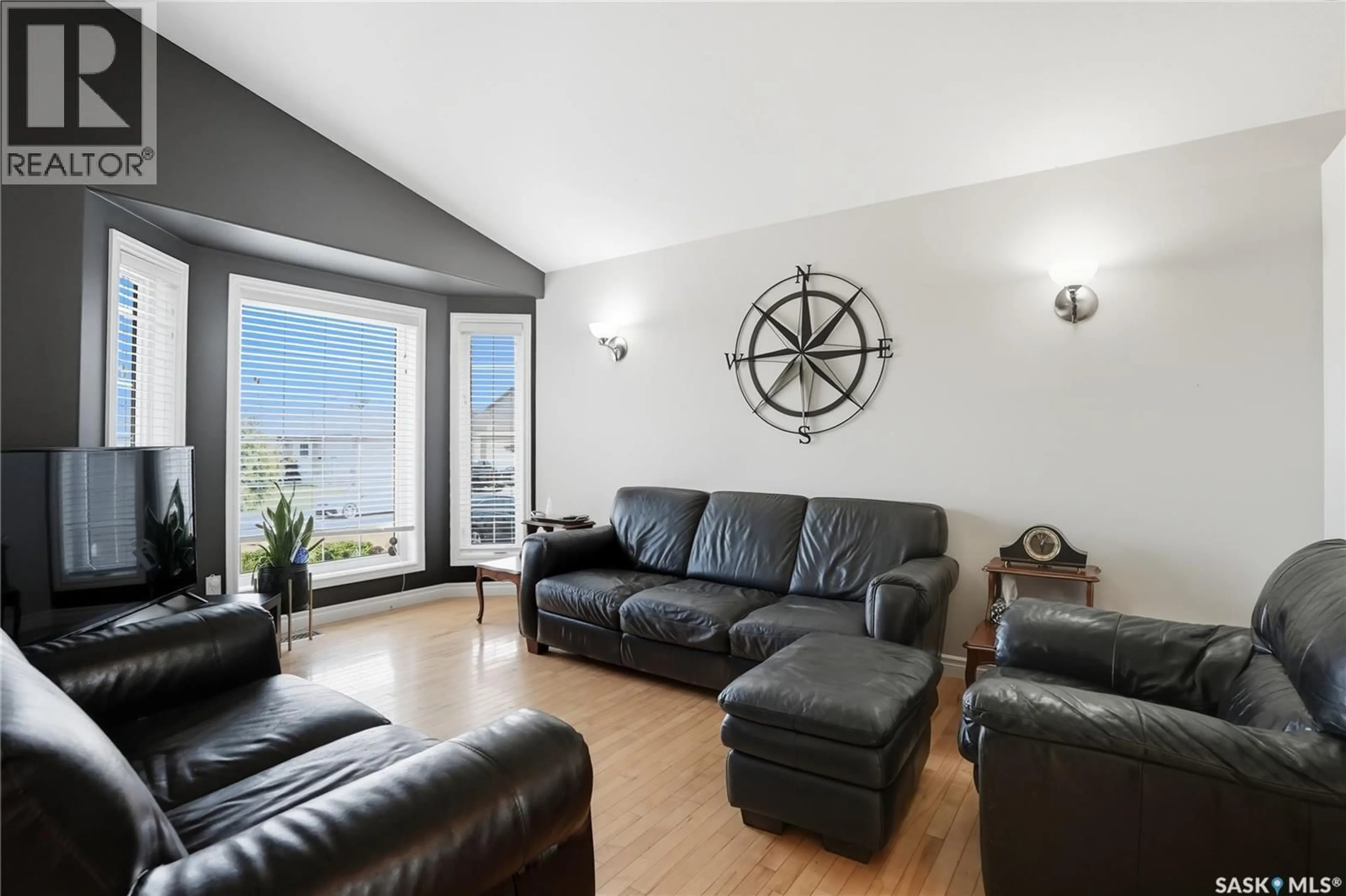 Living room with furniture, wood/laminate floor for 123 MARTIN CRESCENT, Saskatoon Saskatchewan S7T0A1