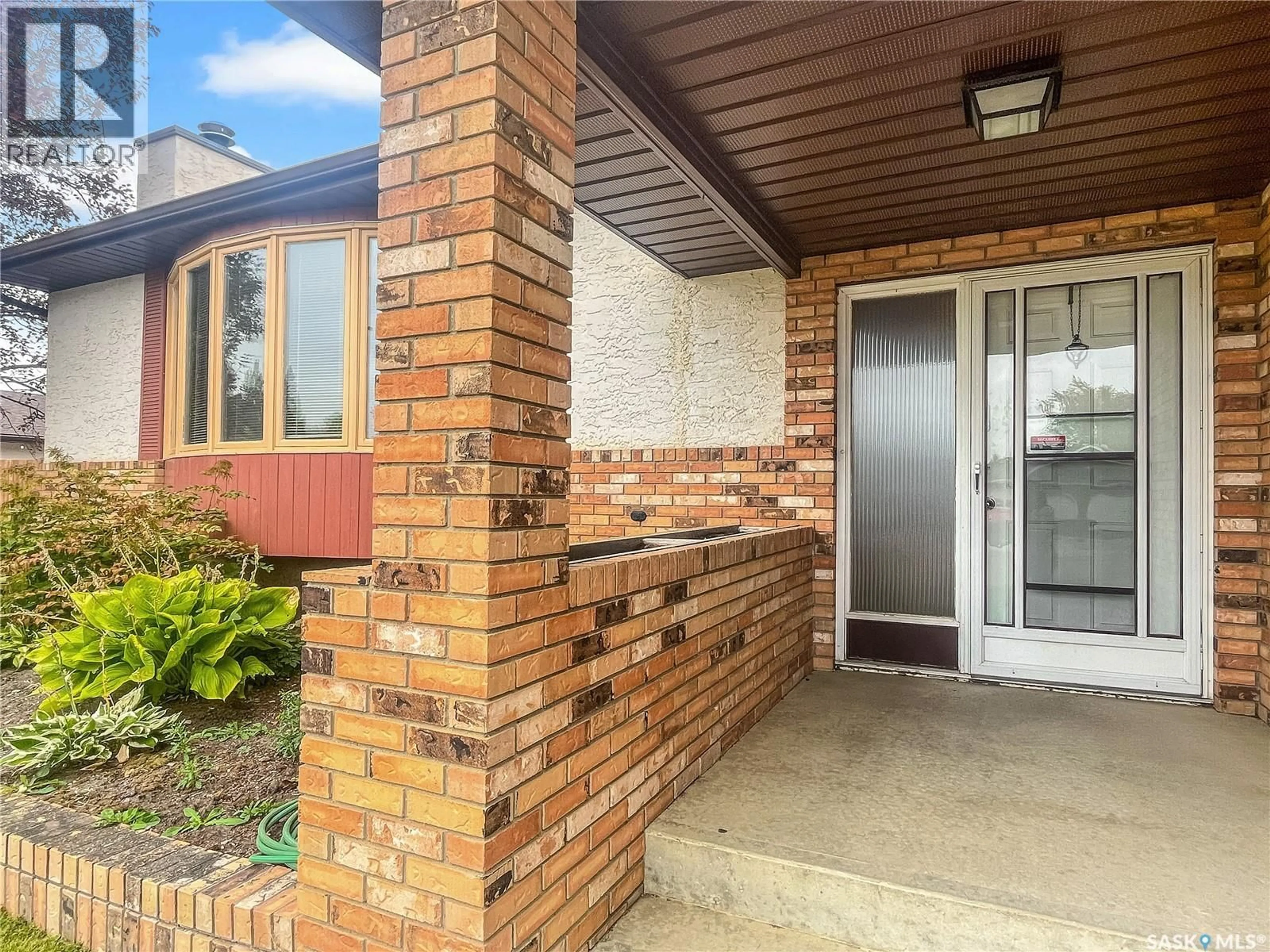 Home with brick exterior material, street for 11206 GARDINER DRIVE, North Battleford Saskatchewan S9A3M6