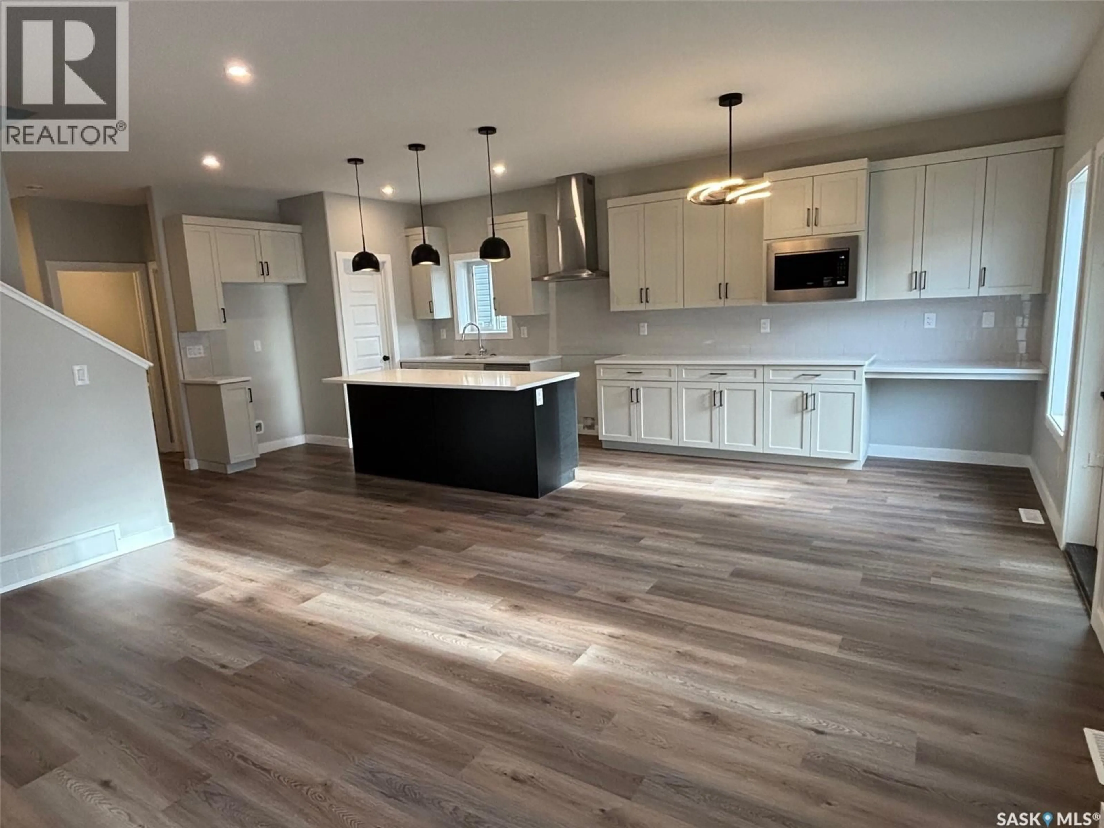 Open concept kitchen, wood/laminate floor for 486 DORAN CRESCENT, Saskatoon Saskatchewan S7V1W2