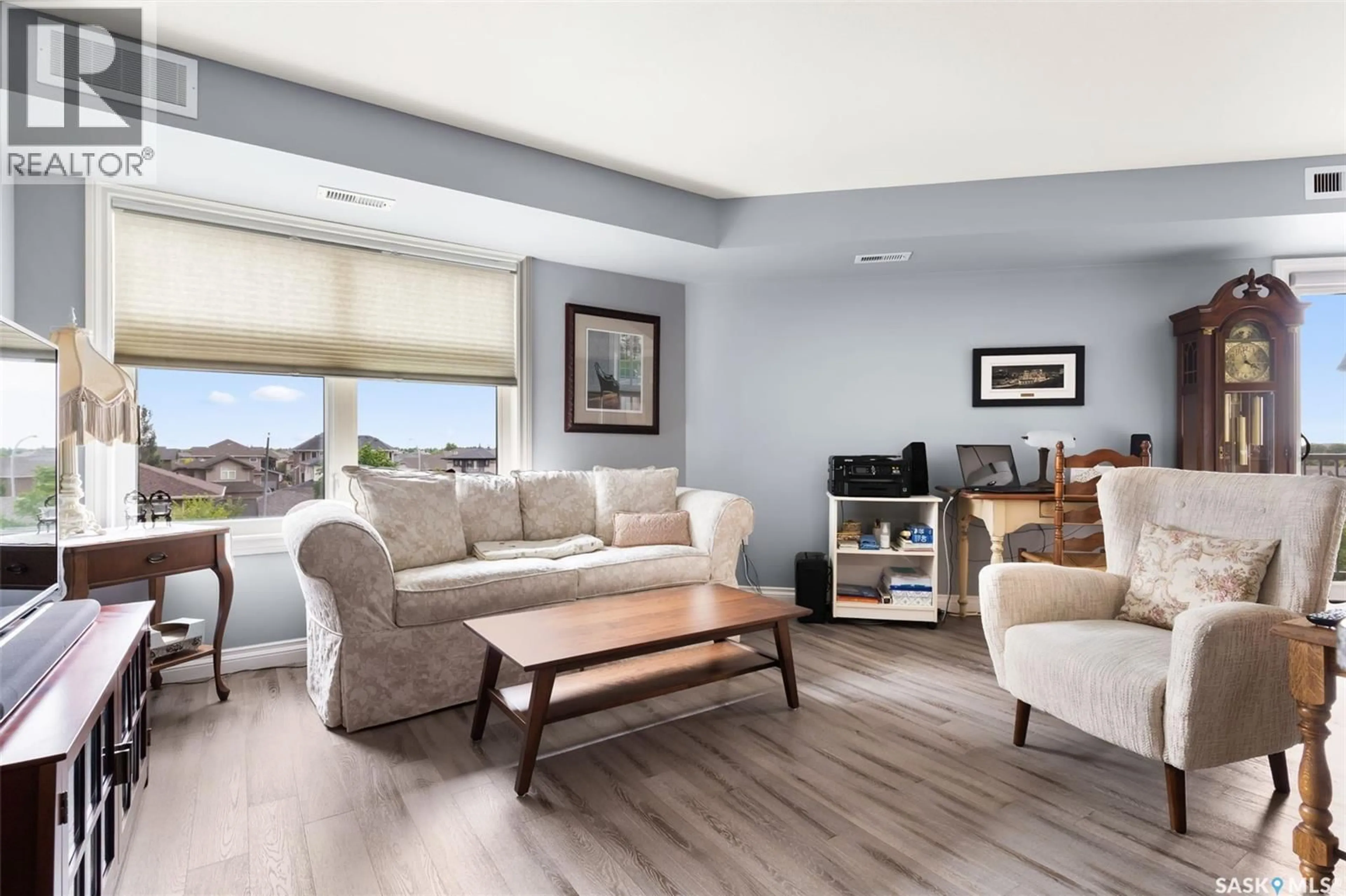 Living room with furniture, wood/laminate floor for 3630 E - 314 HAUGHTON ROAD, Regina Saskatchewan S4V1P1