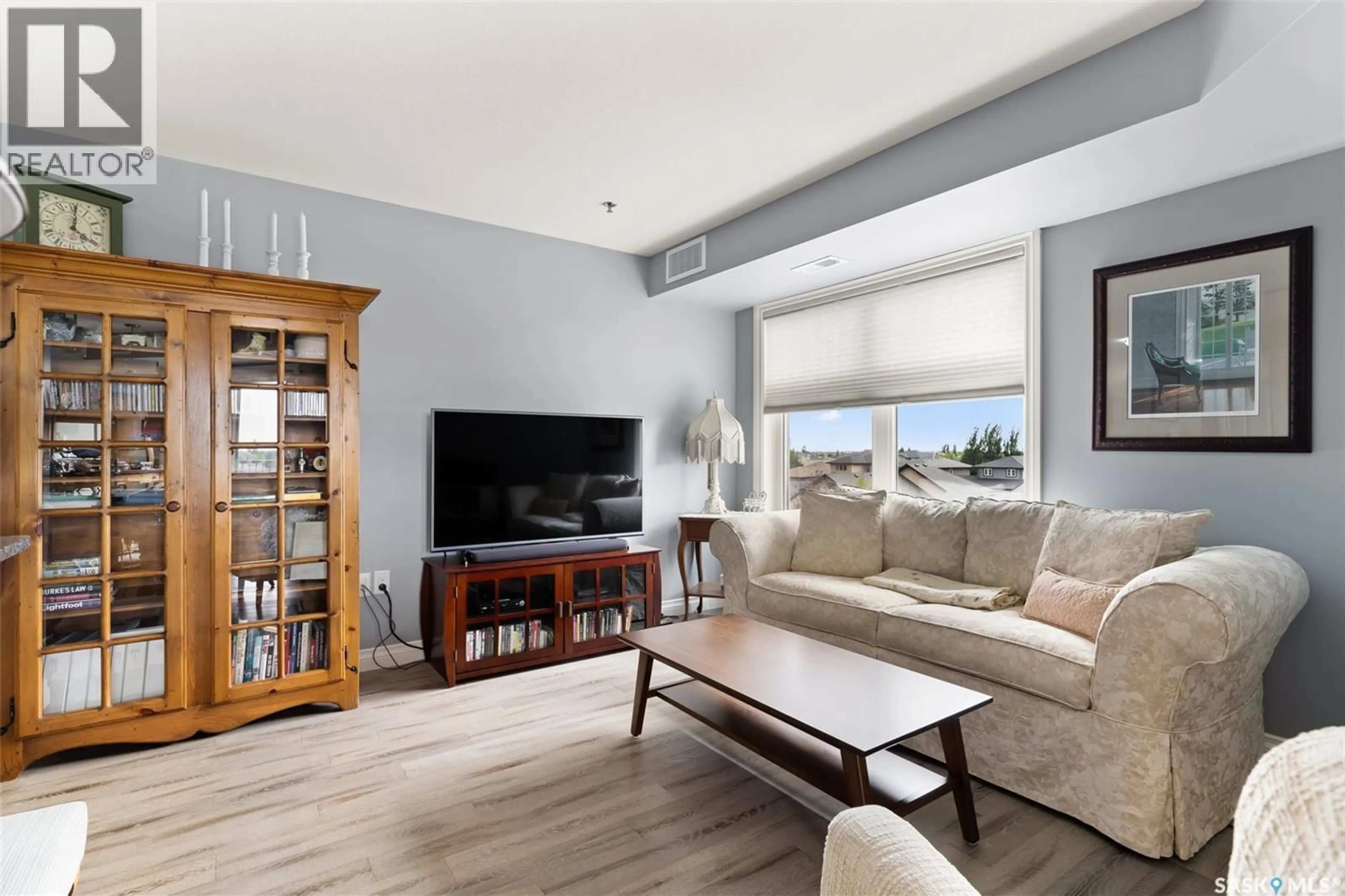 Living room with furniture, wood/laminate floor for 3630 E - 314 HAUGHTON ROAD, Regina Saskatchewan S4V1P1