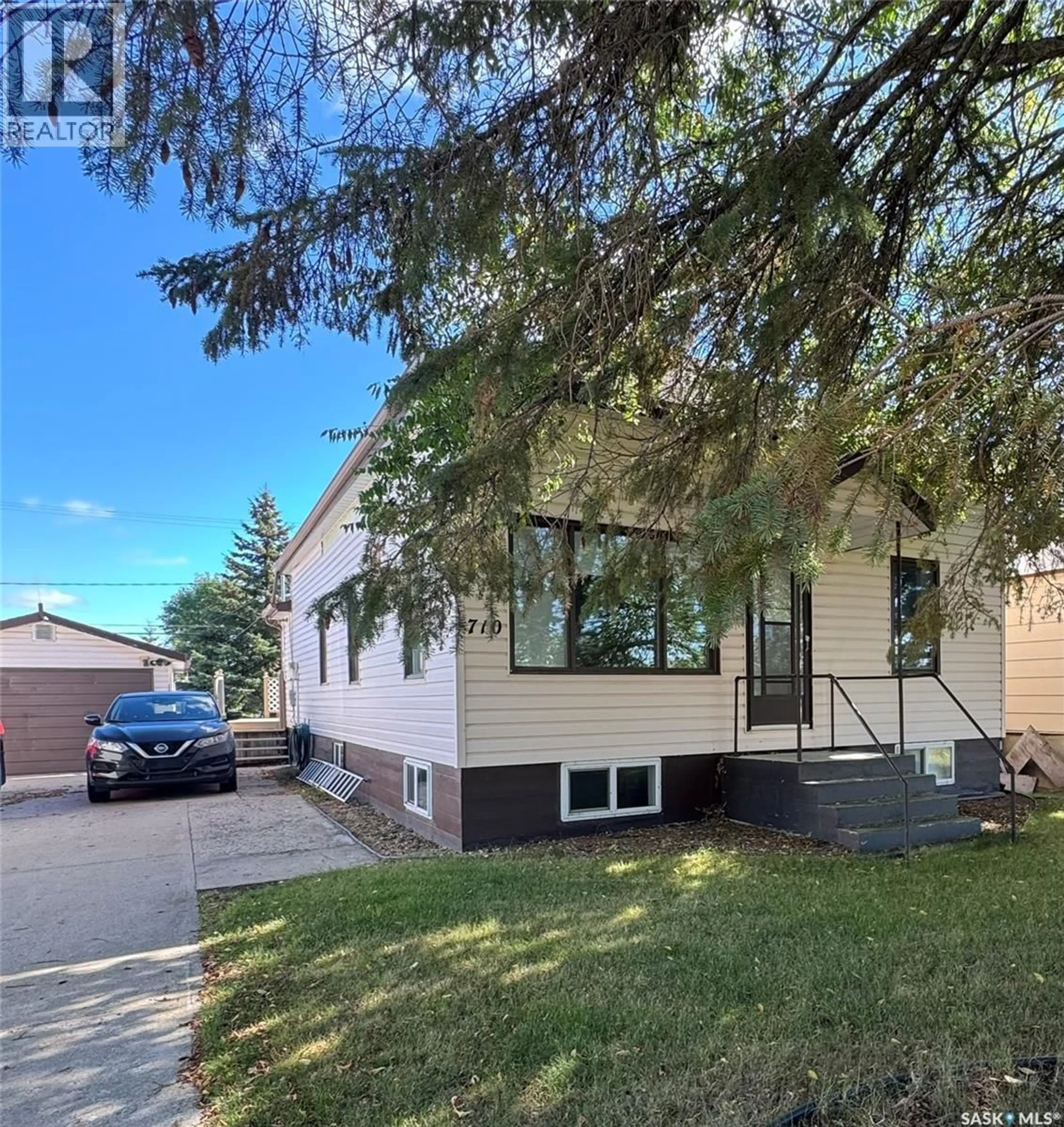Home with vinyl exterior material, street for 710 PRINCE STREET, Hudson Bay Saskatchewan S0E0Y0