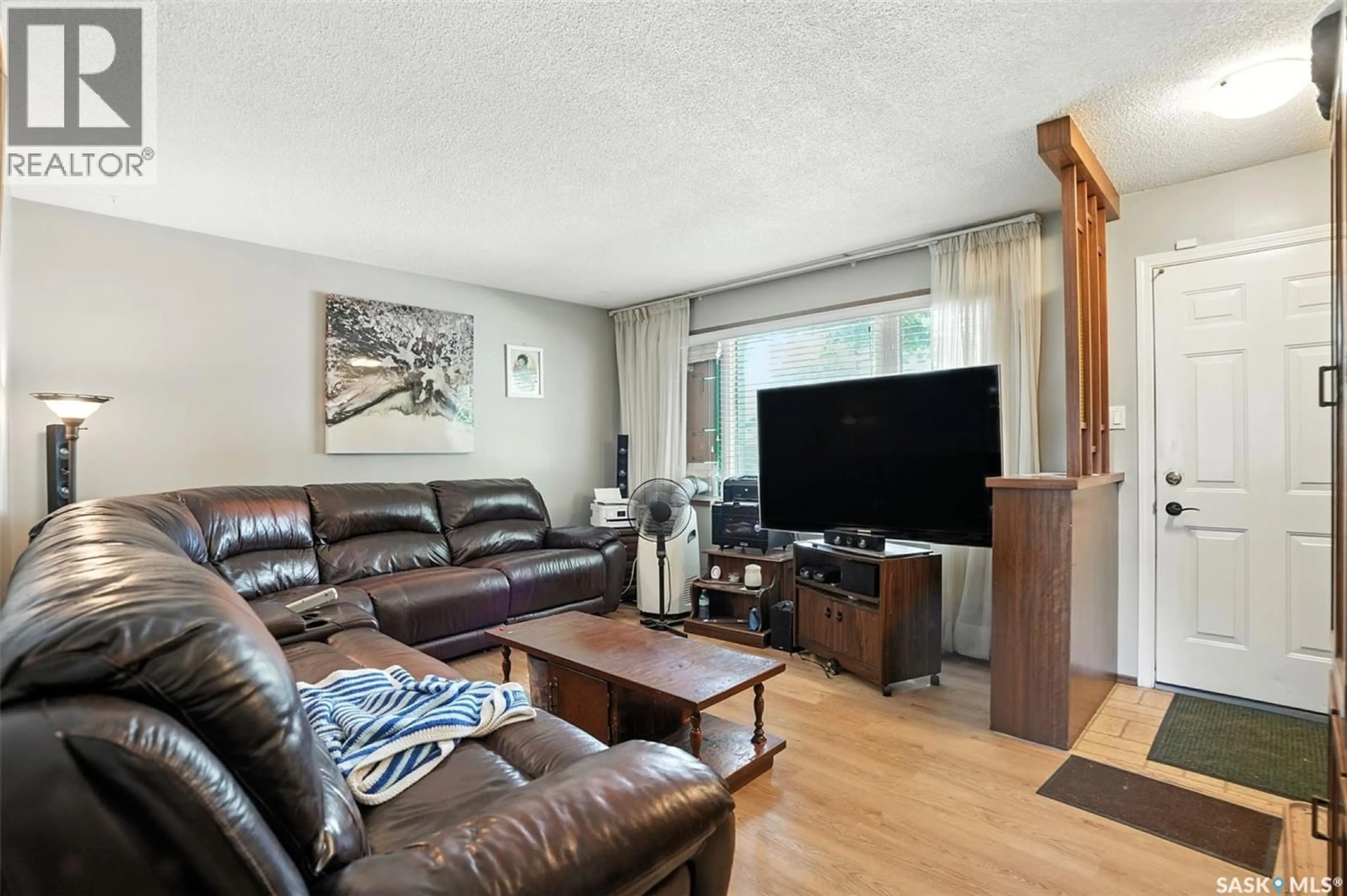Living room with furniture, wood/laminate floor for 97 MAXWELL CRESCENT, Saskatoon Saskatchewan S7L3Y4