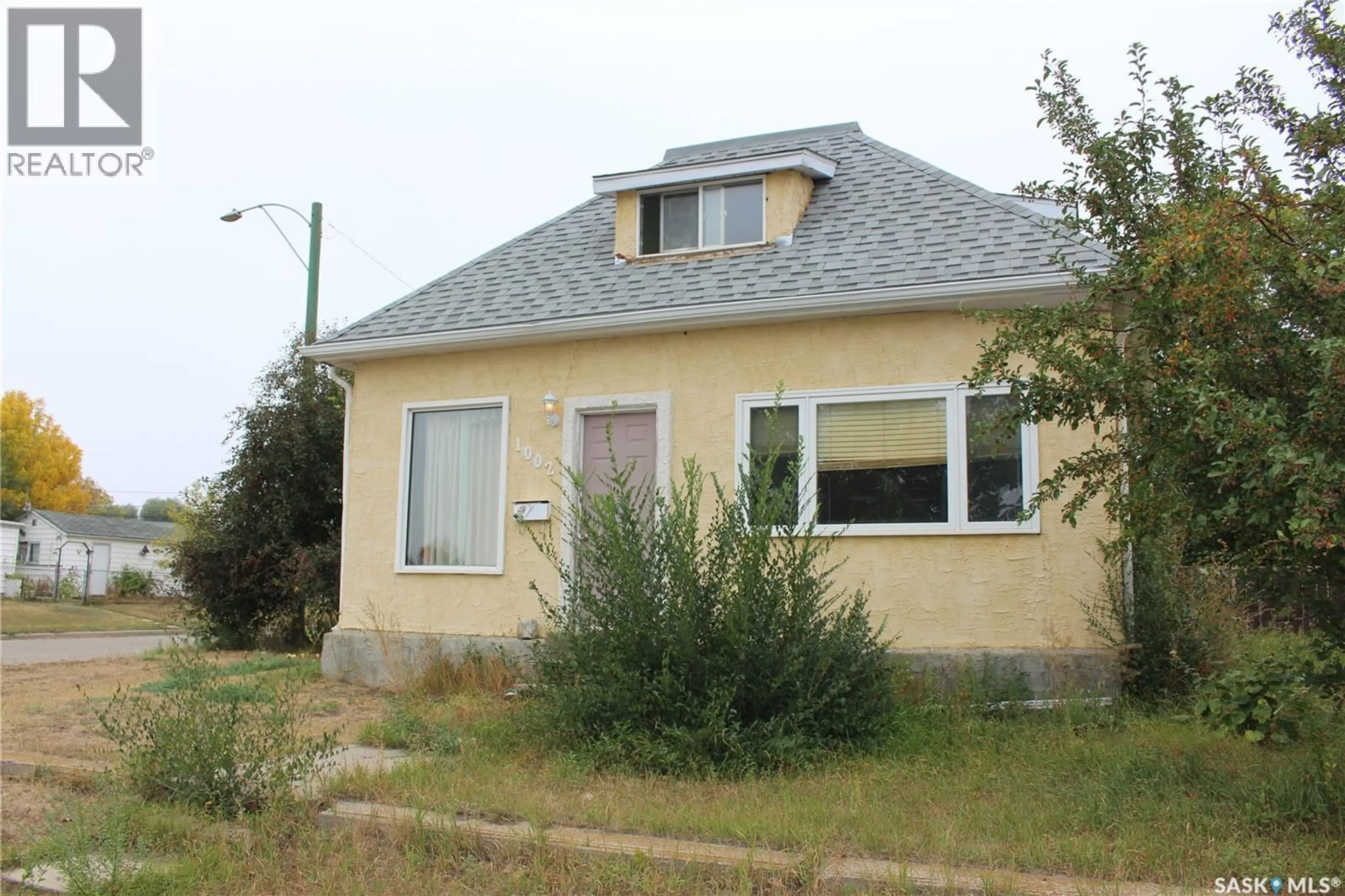 Home with vinyl exterior material, street for 1002 OMINICA STREET, Moose Jaw Saskatchewan S6H0J3