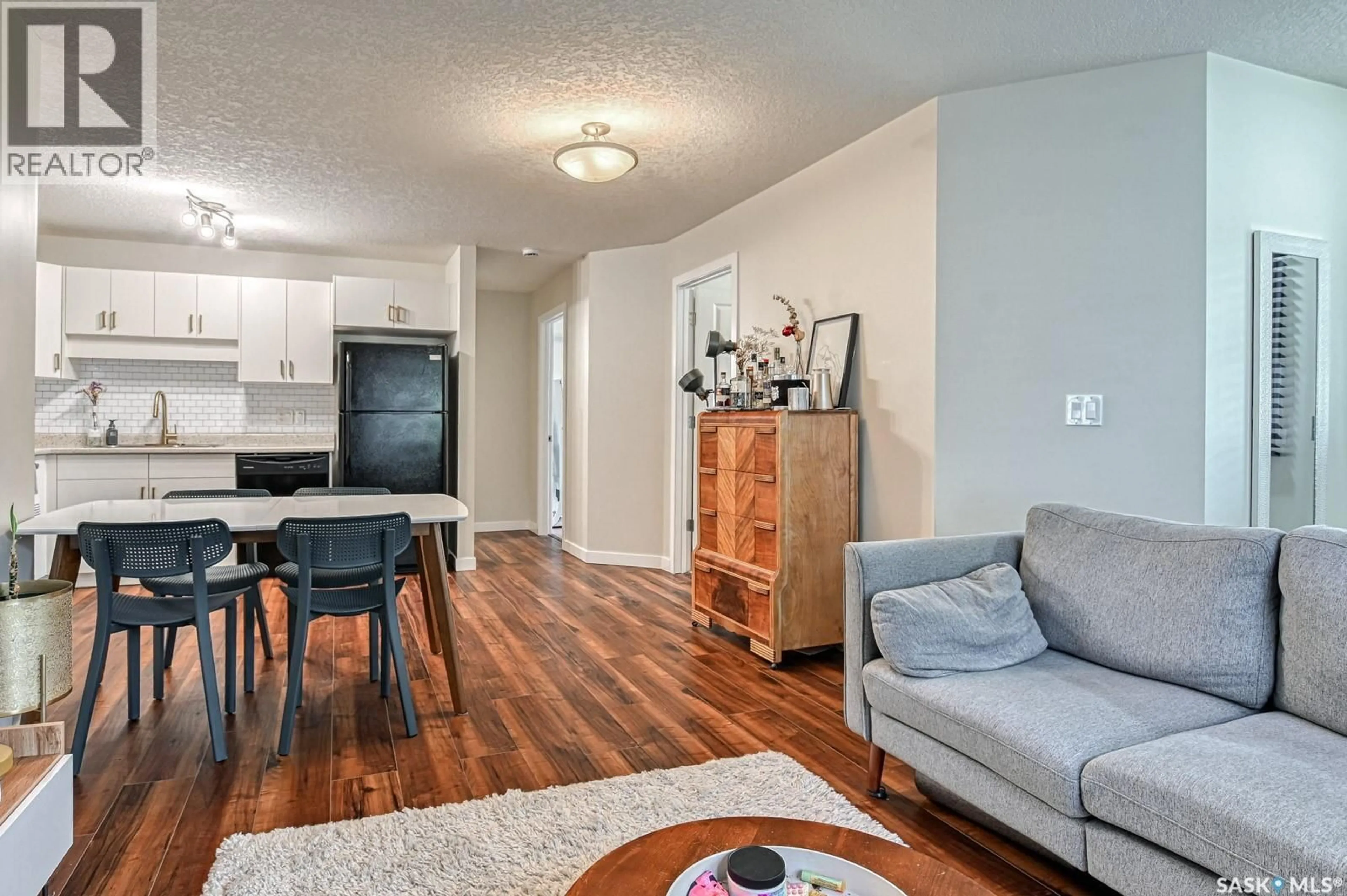 Living room with furniture, wood/laminate floor for 93 - 5525 BLAKE CRESCENT, Regina Saskatchewan S4X0J1