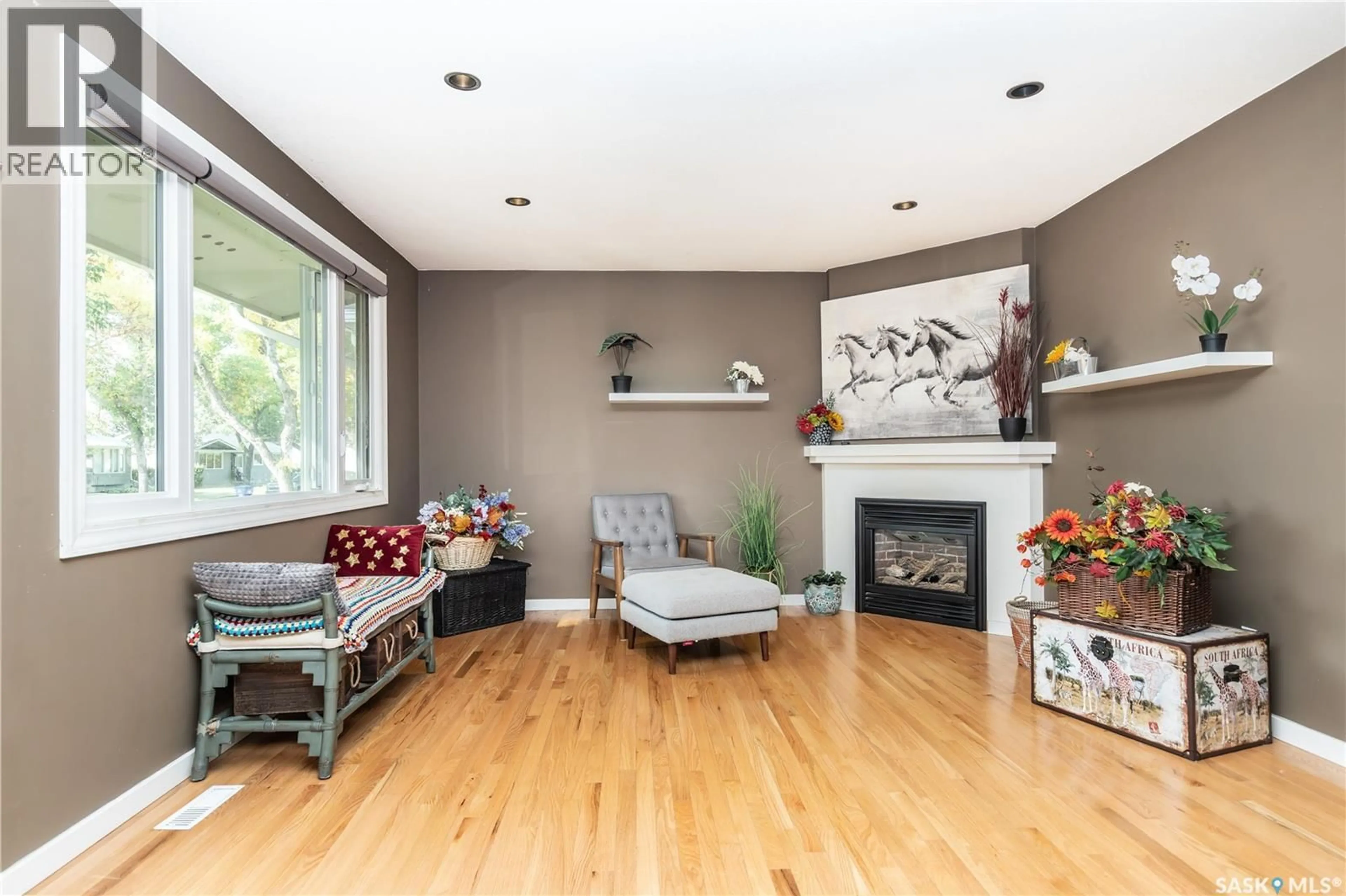 Living room with furniture, wood/laminate floor for 227 MCMASTER CRESCENT, Saskatoon Saskatchewan S7H4E4
