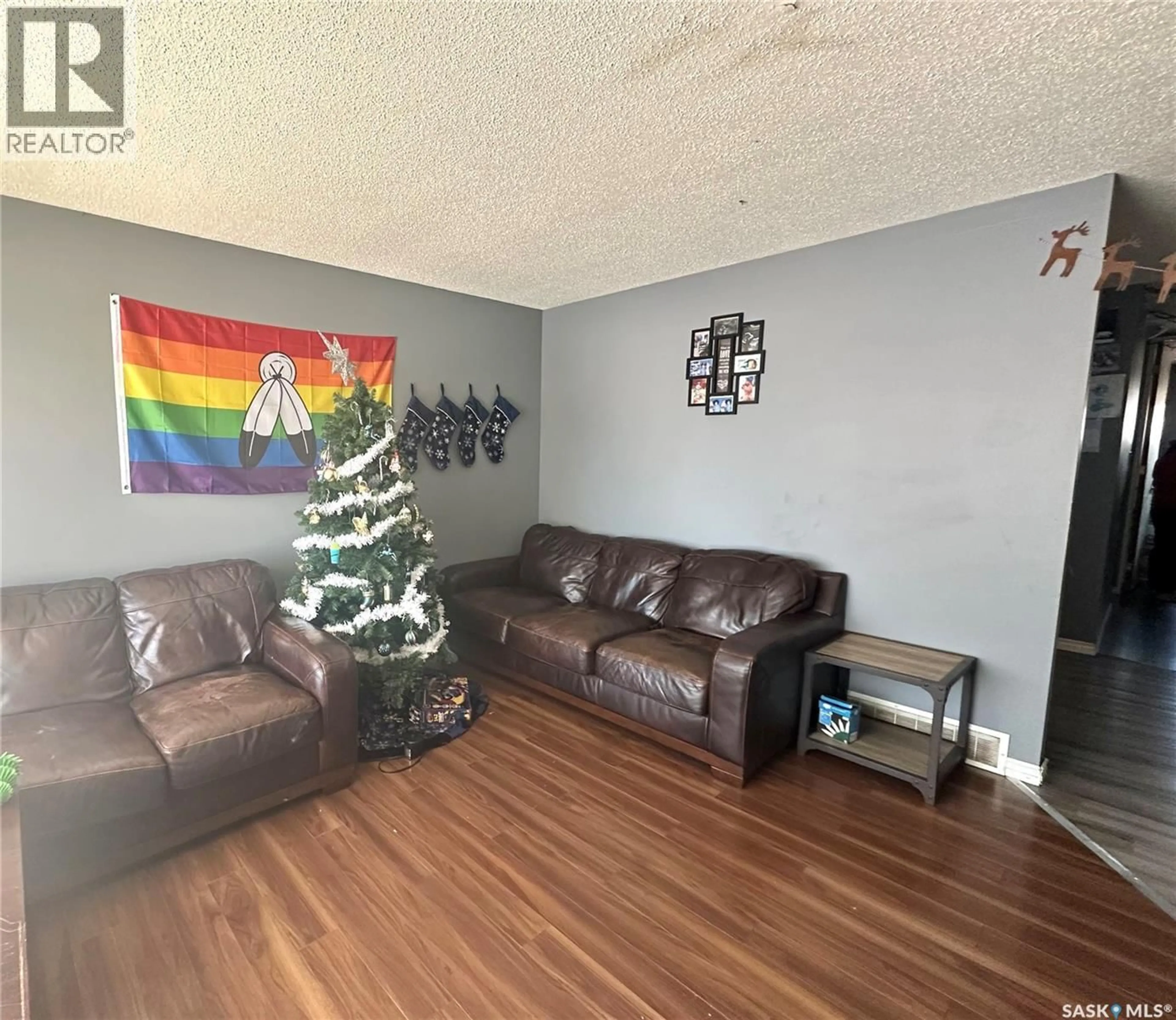 Living room with furniture, wood/laminate floor for 1091 109TH STREET, North Battleford Saskatchewan S9A2E3