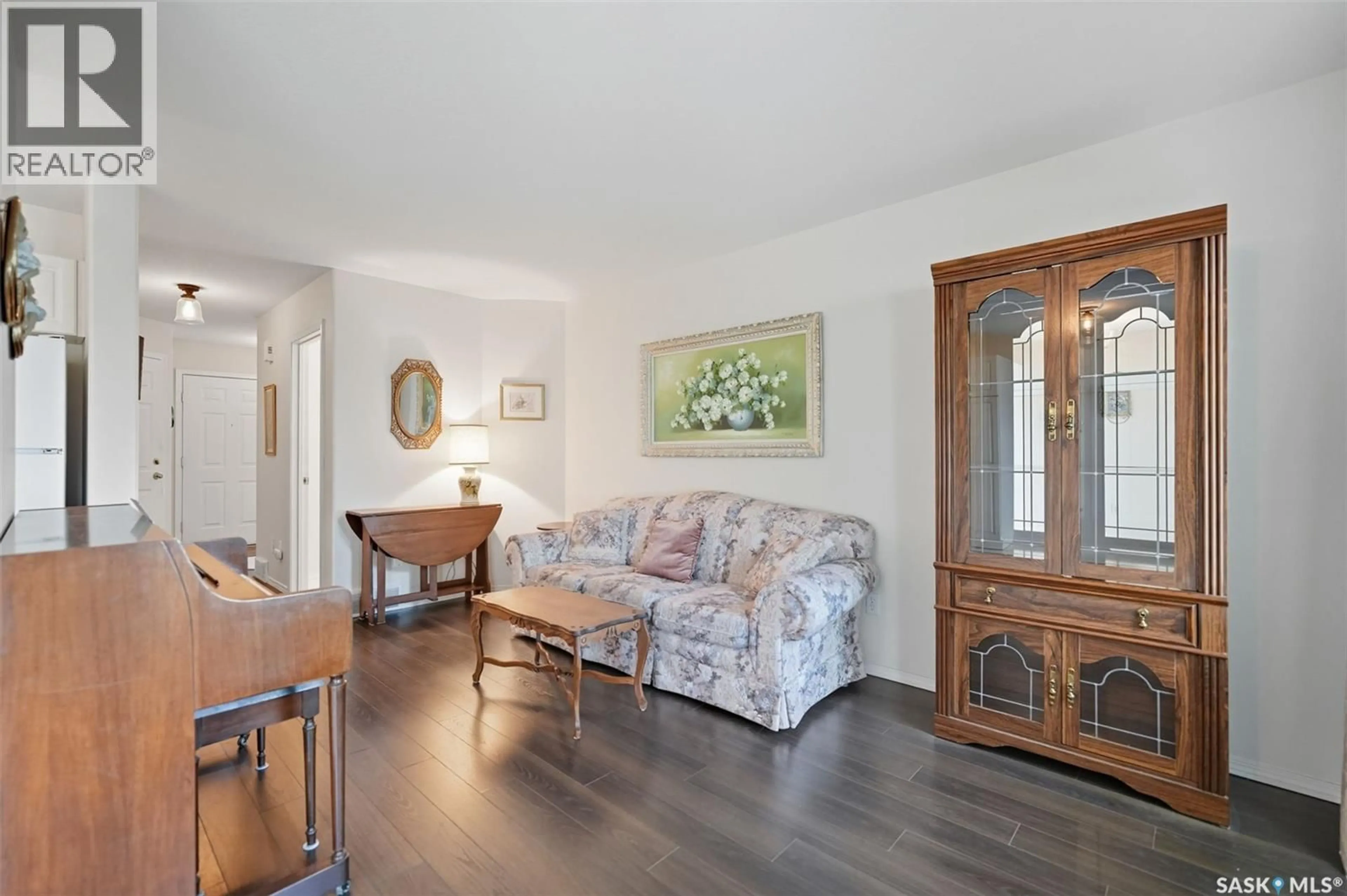 Living room with furniture, wood/laminate floor for 15 410 KEEVIL CRESCENT, Saskatoon Saskatchewan S7N4R6