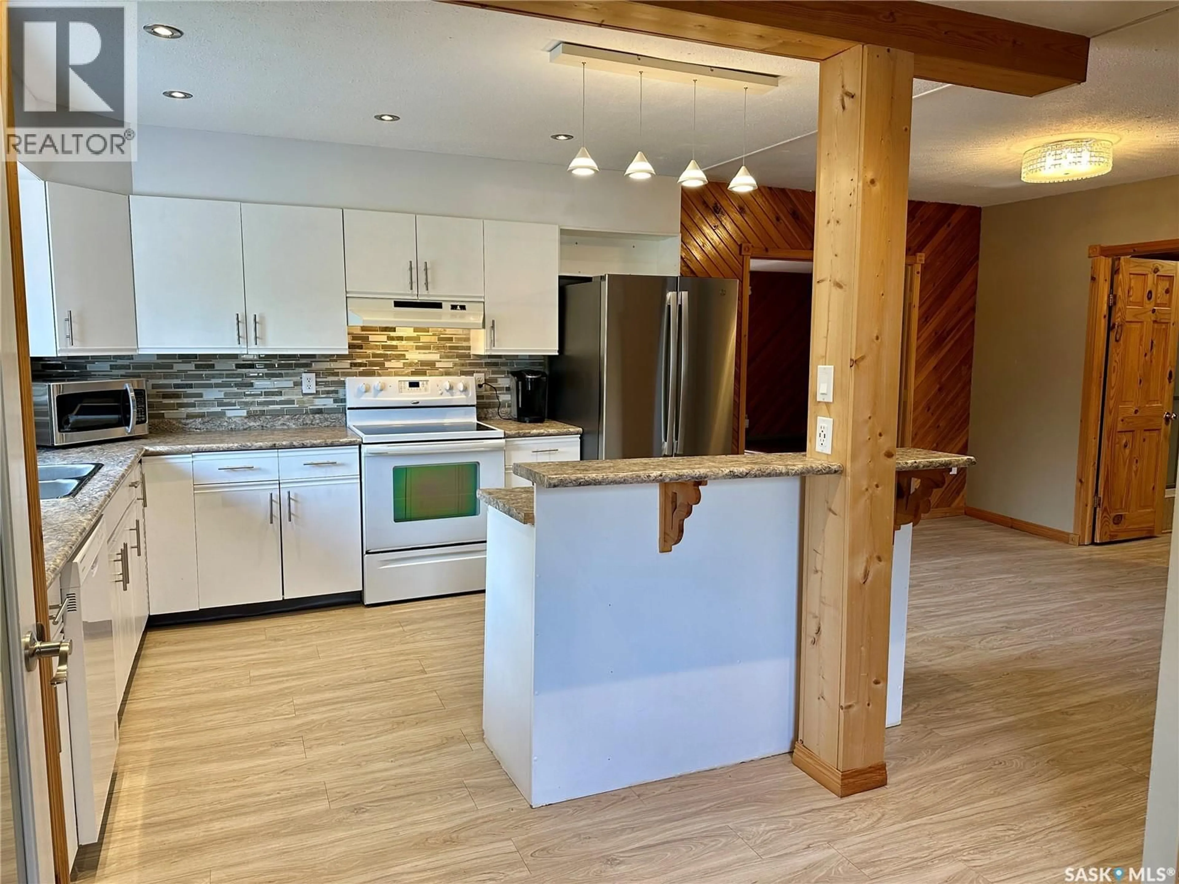 Open concept kitchen, wood/laminate floor for 200 VICKERS CRESCENT, Air Ronge Saskatchewan S0J3G0