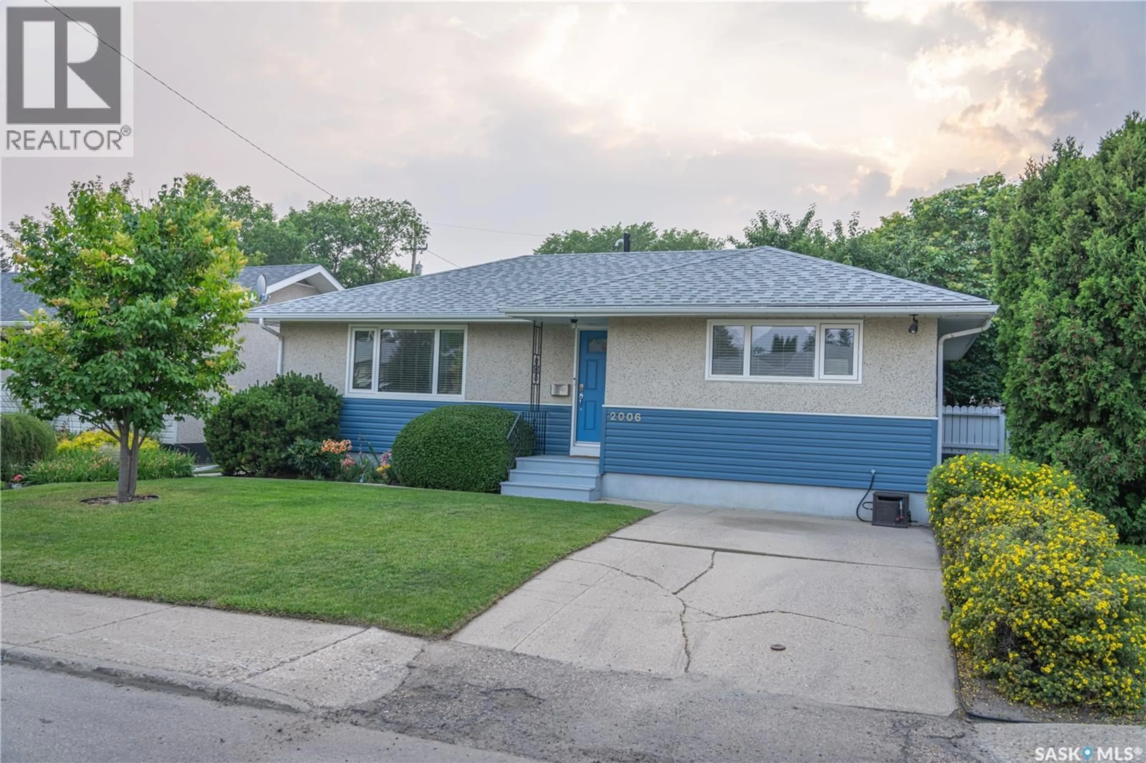 Home with vinyl exterior material, street for 2006 LOUISE AVENUE, Saskatoon Saskatchewan S7J2C2