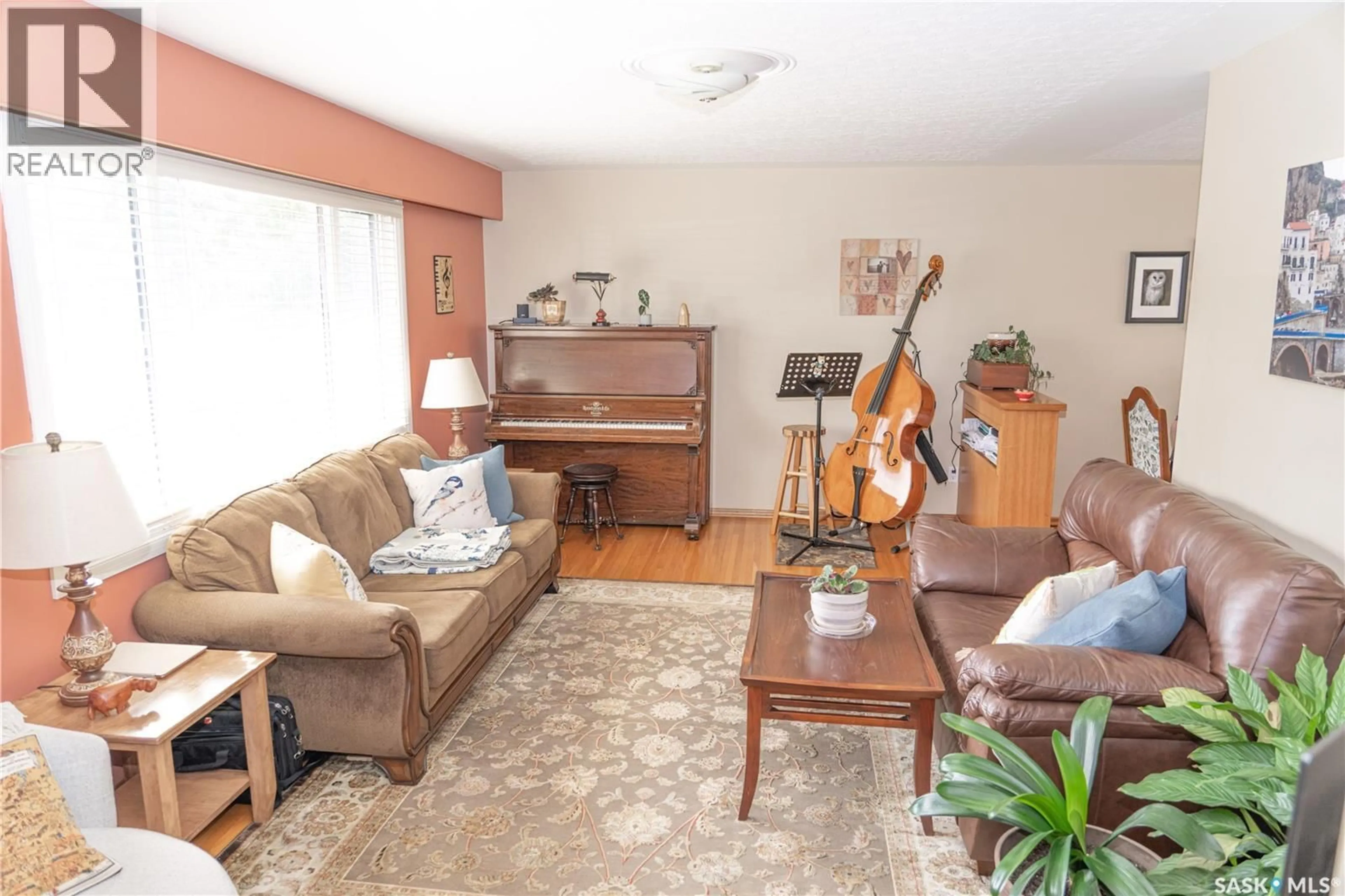 Living room with furniture, wood/laminate floor for 2006 LOUISE AVENUE, Saskatoon Saskatchewan S7J2C2