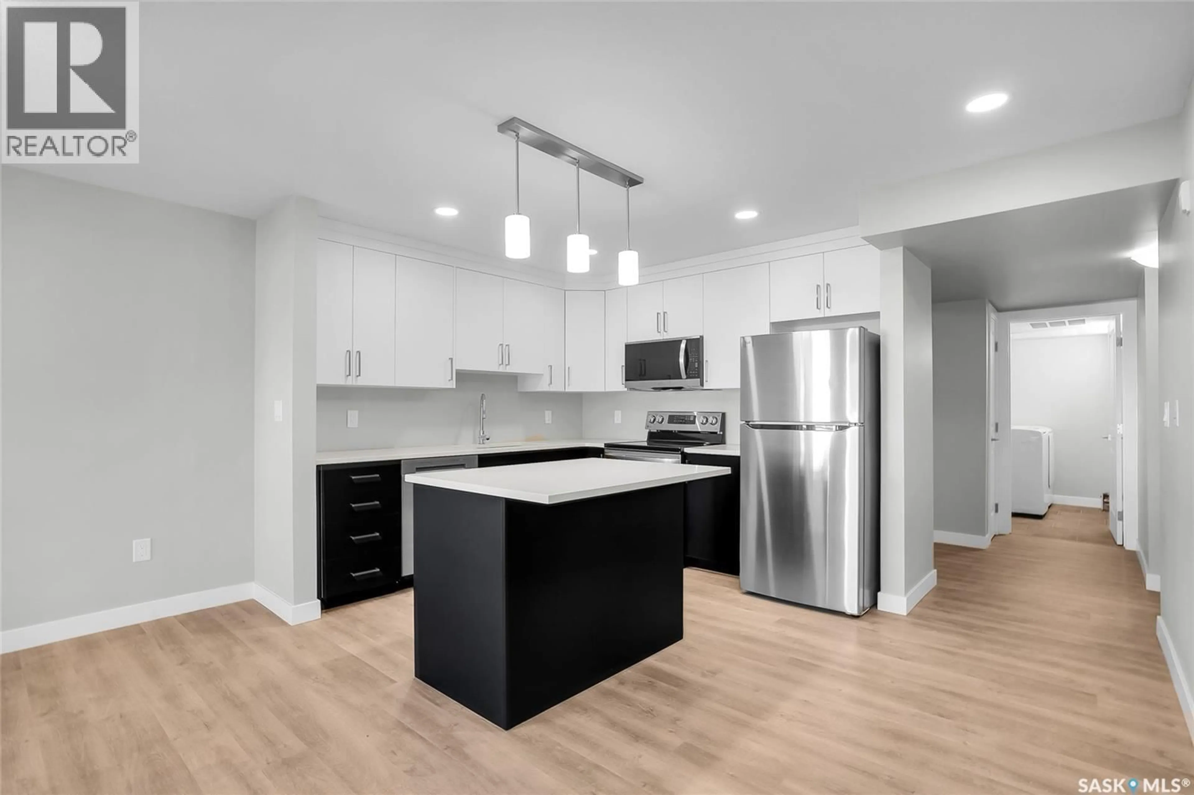 Open concept kitchen, wood/laminate floor for 109 318 108TH STREET, Saskatoon Saskatchewan S7N1P8