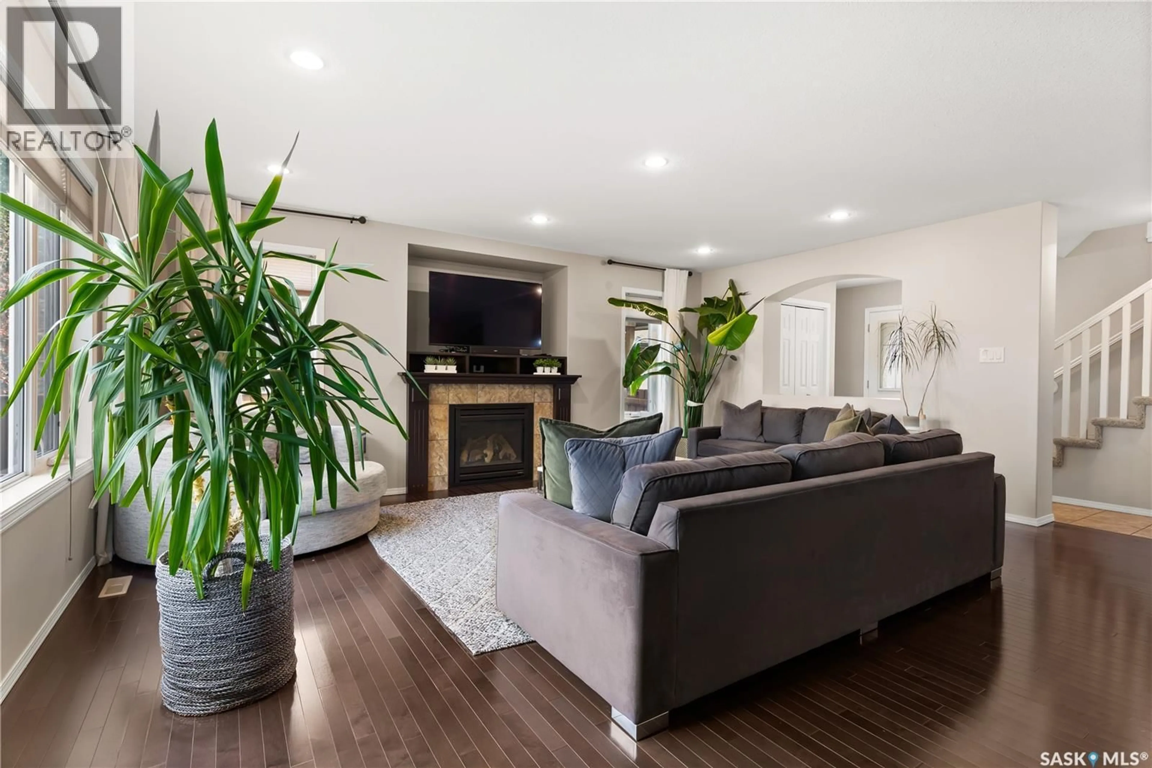 Living room with furniture, wood/laminate floor for 8310 WASCANA GARDENS WAY, Regina Saskatchewan S4V1E9