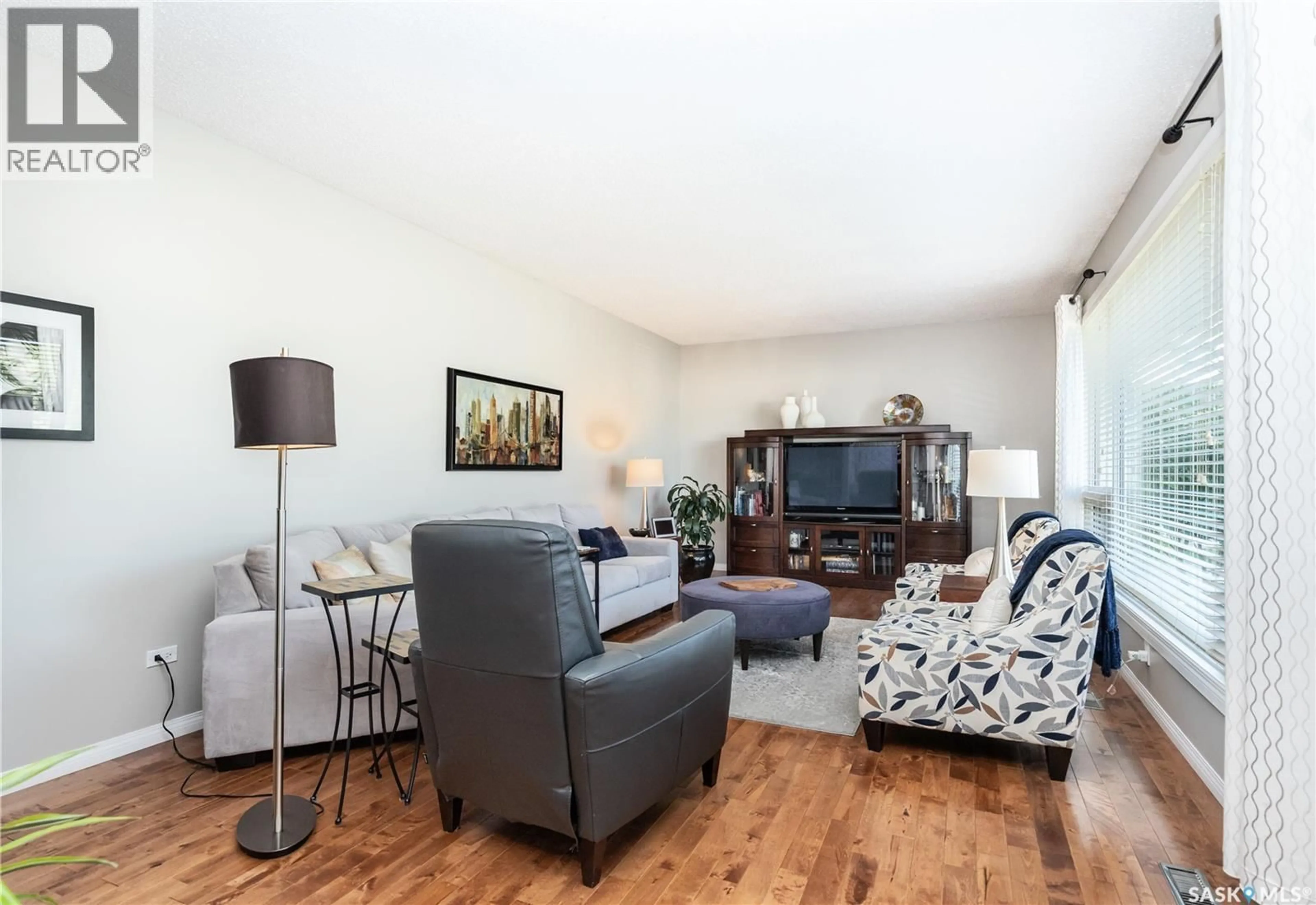 Living room with furniture, wood/laminate floor for 72 DEBORAH CRESCENT, Saskatoon Saskatchewan S7J2W8