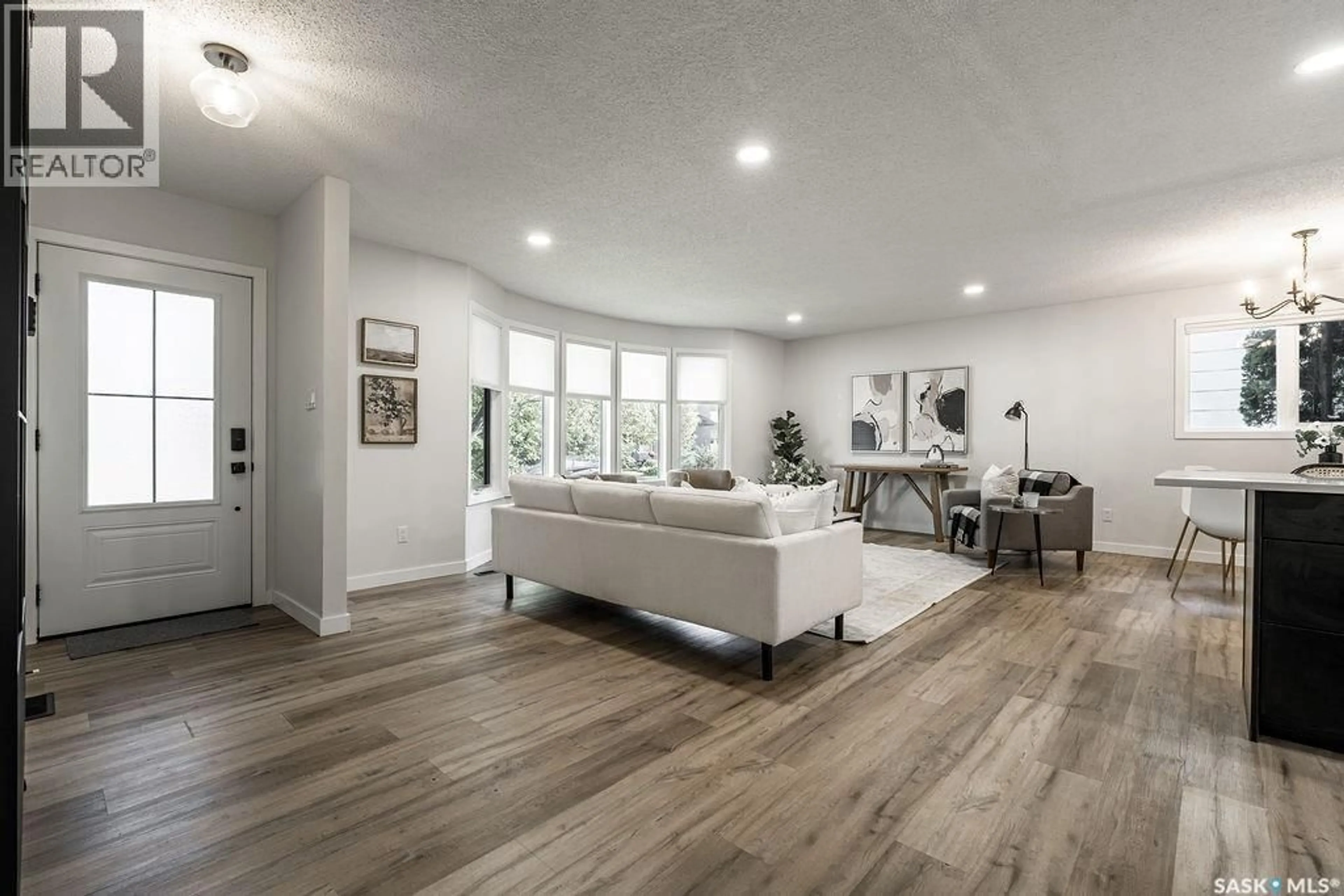 Living room with furniture, wood/laminate floor for 322 STECHISHIN WAY, Saskatoon Saskatchewan S7K5R1
