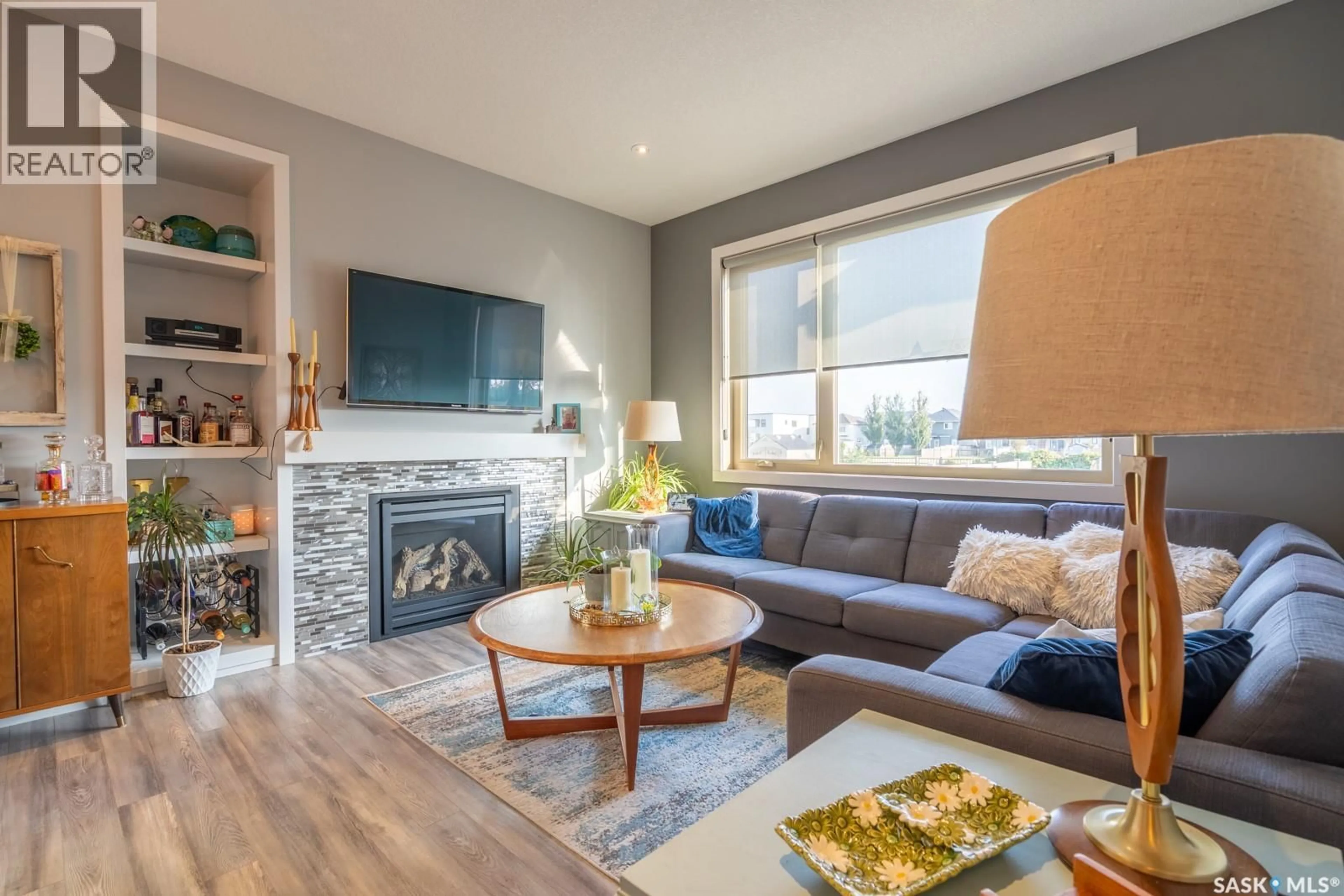 Living room with furniture, wood/laminate floor for 5760 PEARSALL CRESCENT, Regina Saskatchewan S4W0K2