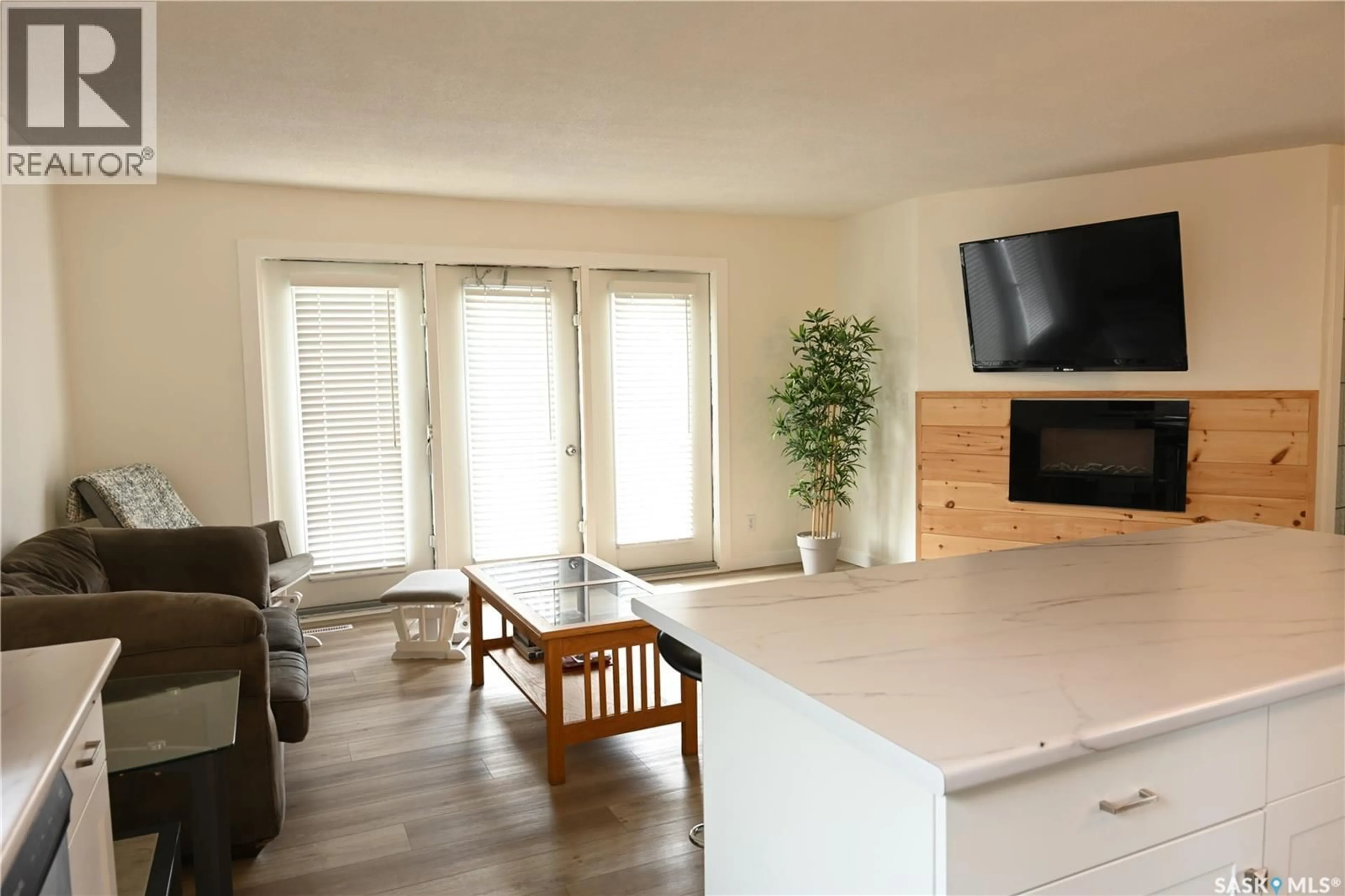 Living room with furniture, wood/laminate floor for 103 3RD AVENUE, Hanley Saskatchewan S0G2E0