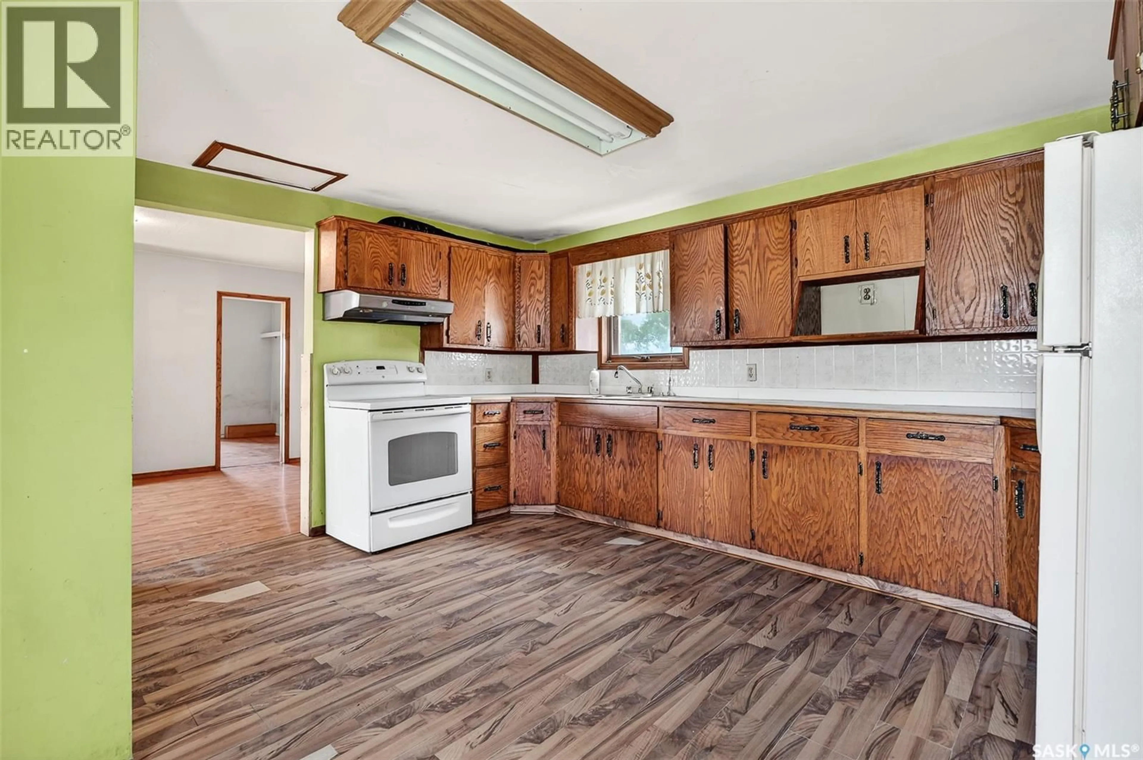 Open concept kitchen, wood/laminate floor for 1038 ATHABASCA STREET, Moose Jaw Saskatchewan S6H0N2