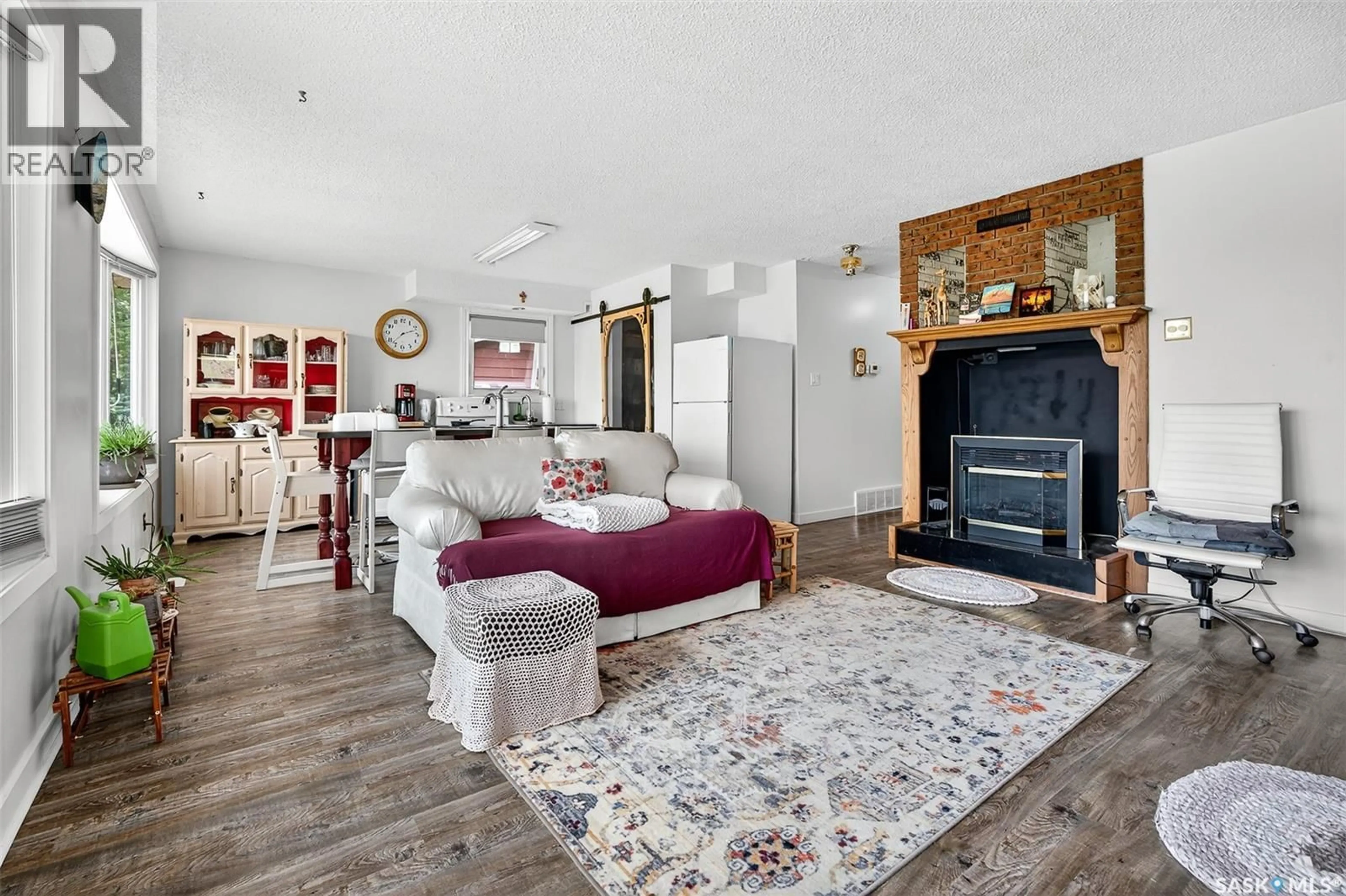 Living room with furniture, wood/laminate floor for 119 NORTH HAVEN ROAD, Marquis Rm No. 191 Saskatchewan S6H7T2