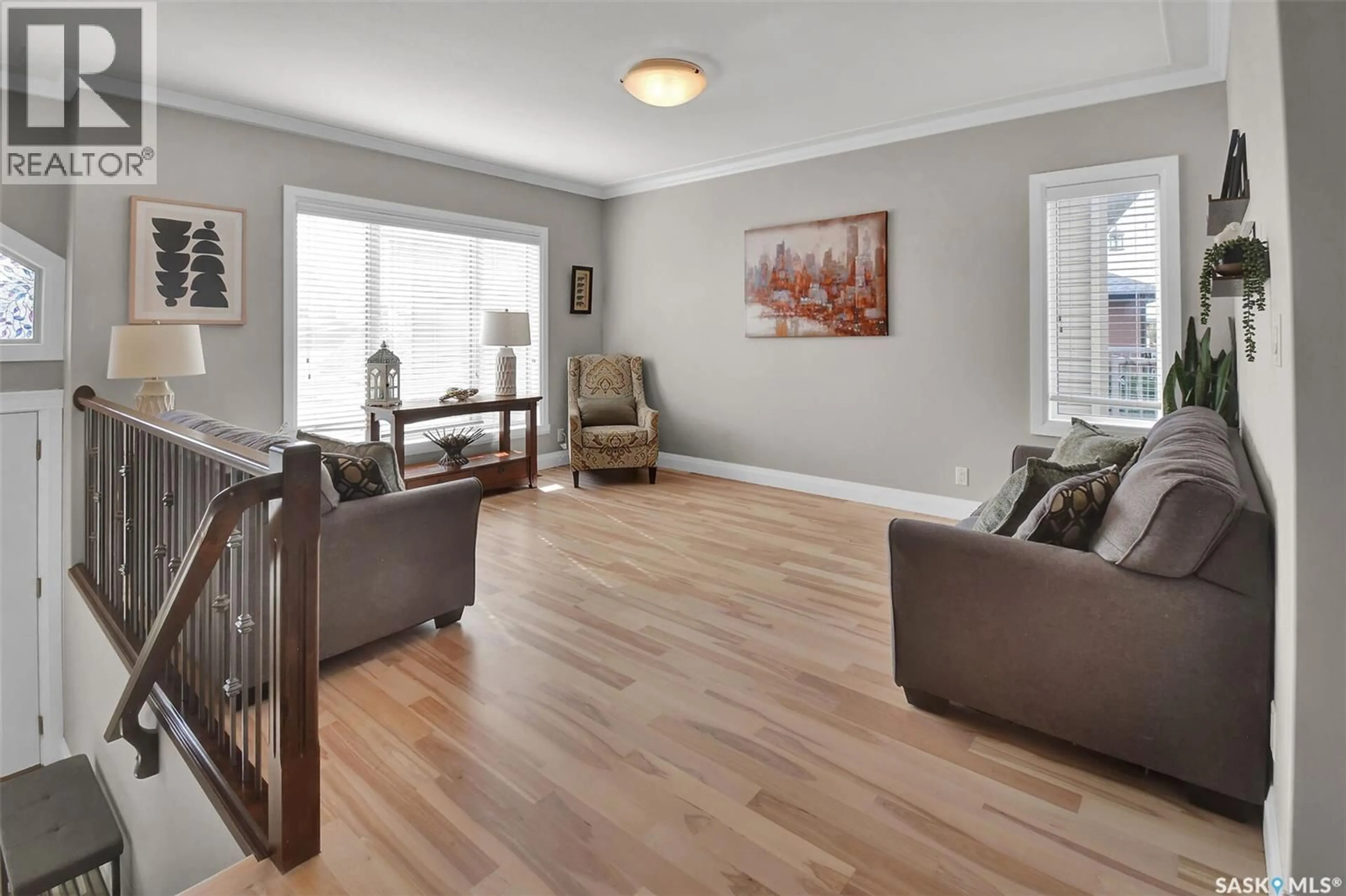 Living room with furniture, wood/laminate floor for 1942 POHORECKY TERRACE, Saskatoon Saskatchewan S7W0J1