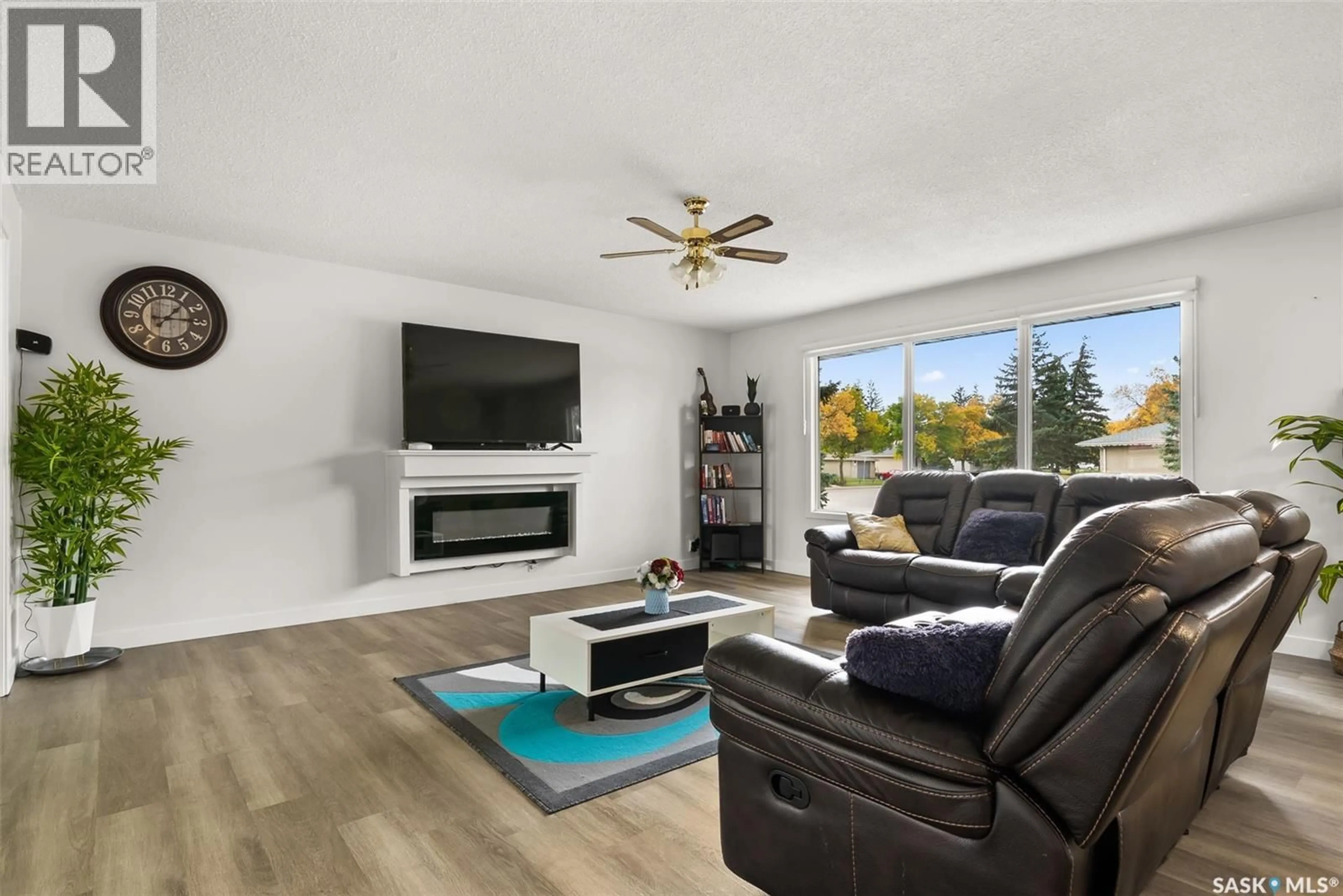 Living room with furniture, wood/laminate floor for 315 MCINTOSH STREET, Regina Saskatchewan S4R5A1