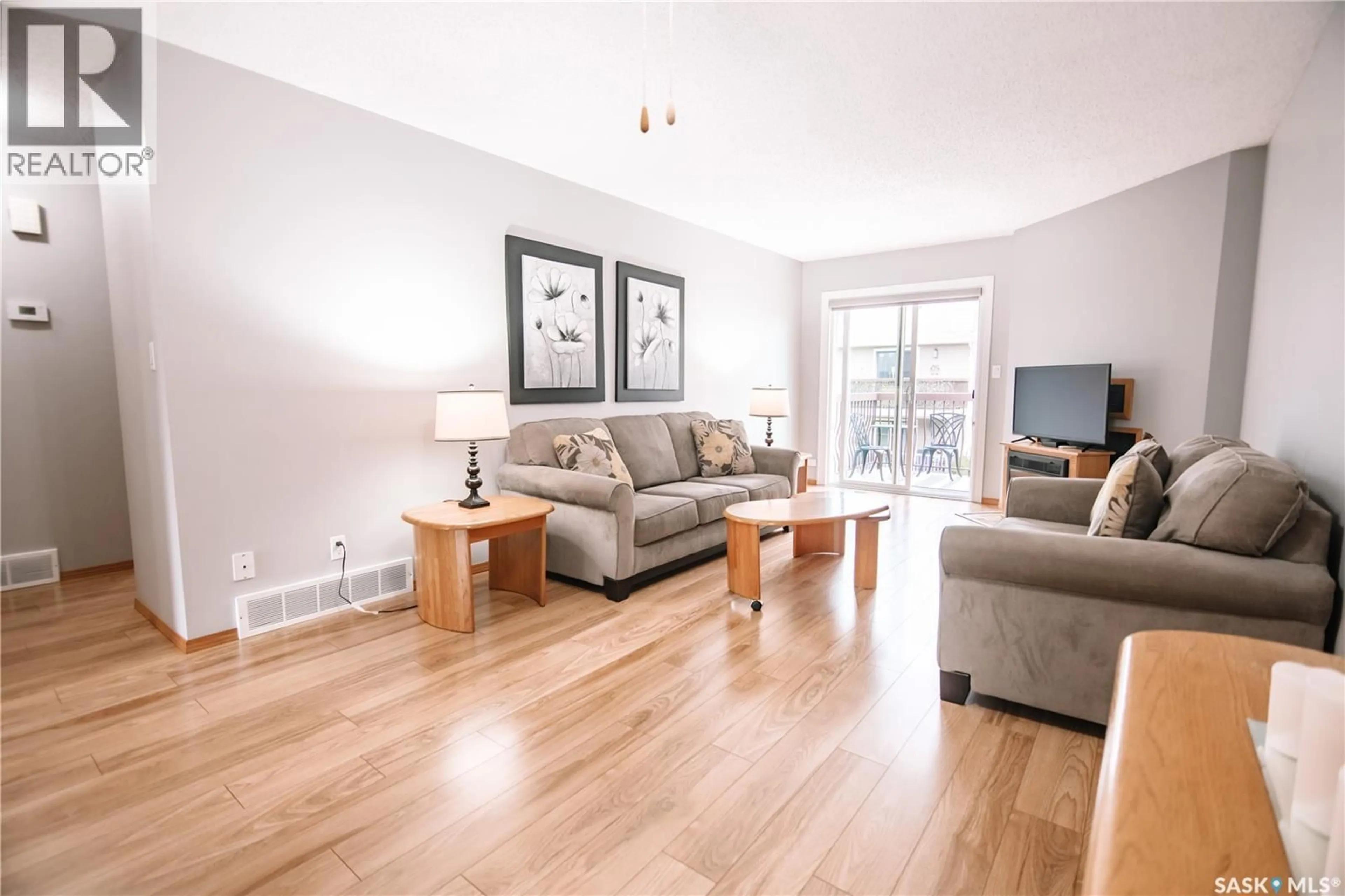 Living room with furniture, wood/laminate floor for 180 CEDAR MEADOW DRIVE, Regina Saskatchewan S4X3J6