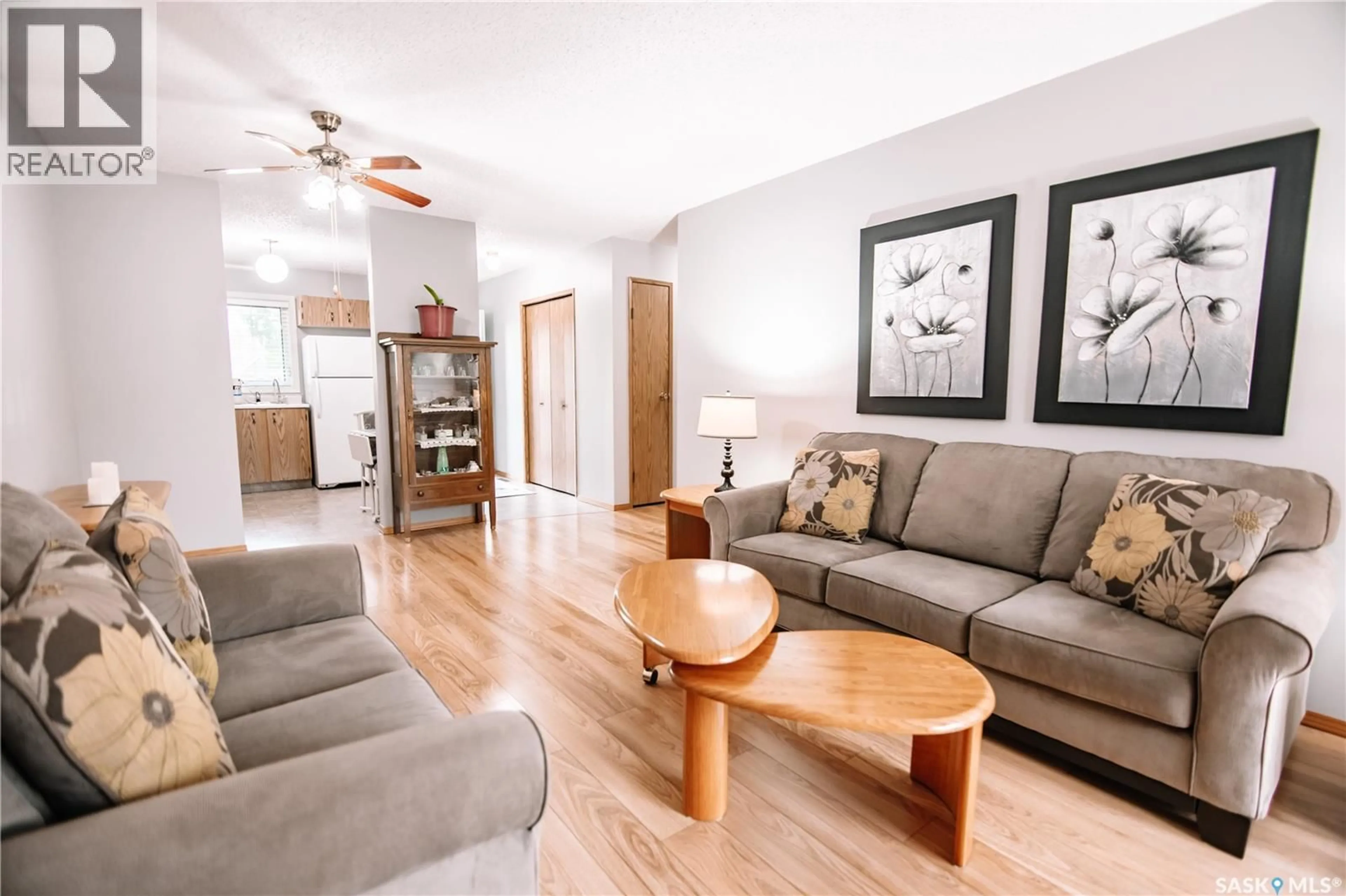 Living room with furniture, wood/laminate floor for 180 CEDAR MEADOW DRIVE, Regina Saskatchewan S4X3J6