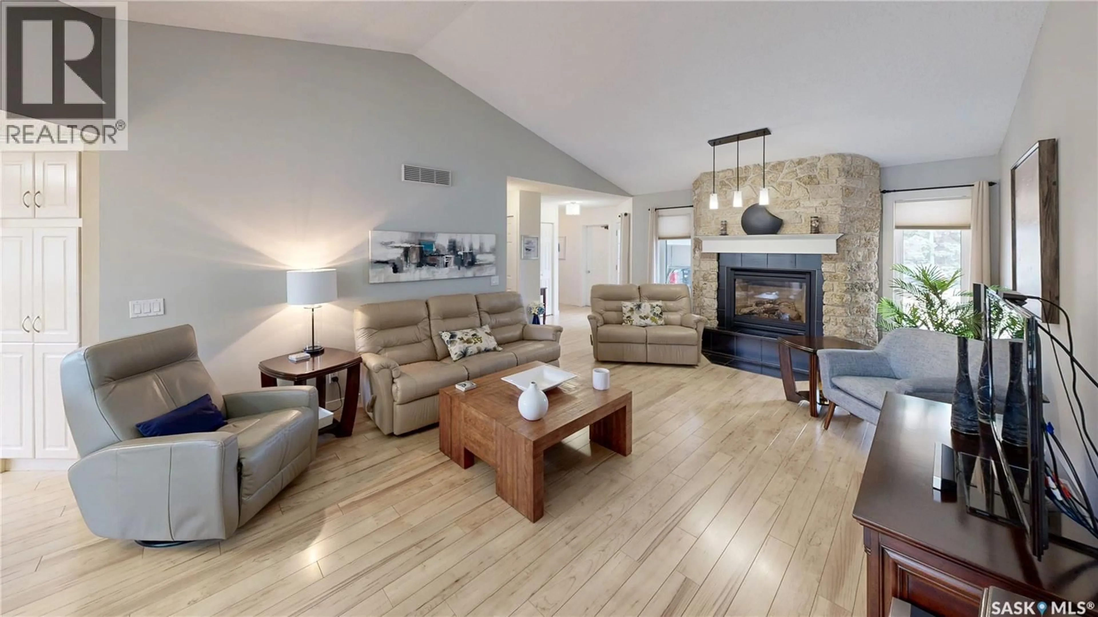 Living room with furniture, wood/laminate floor for 2842 AUDETTE BAY E, Regina Saskatchewan S4V1X1