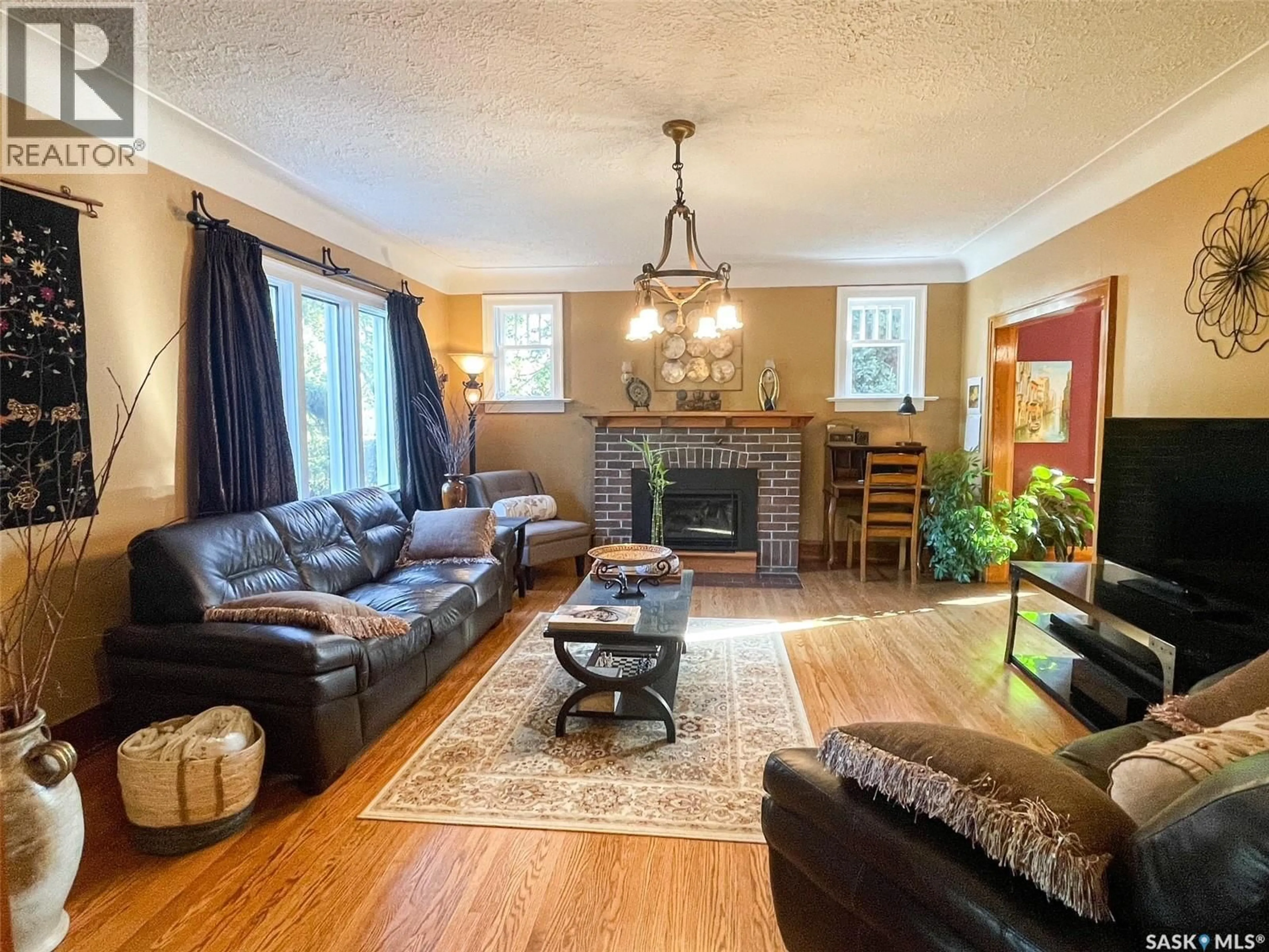 Living room with furniture, wood/laminate floor for 413 CENTRE STREET, Meadow Lake Saskatchewan S9X1E5