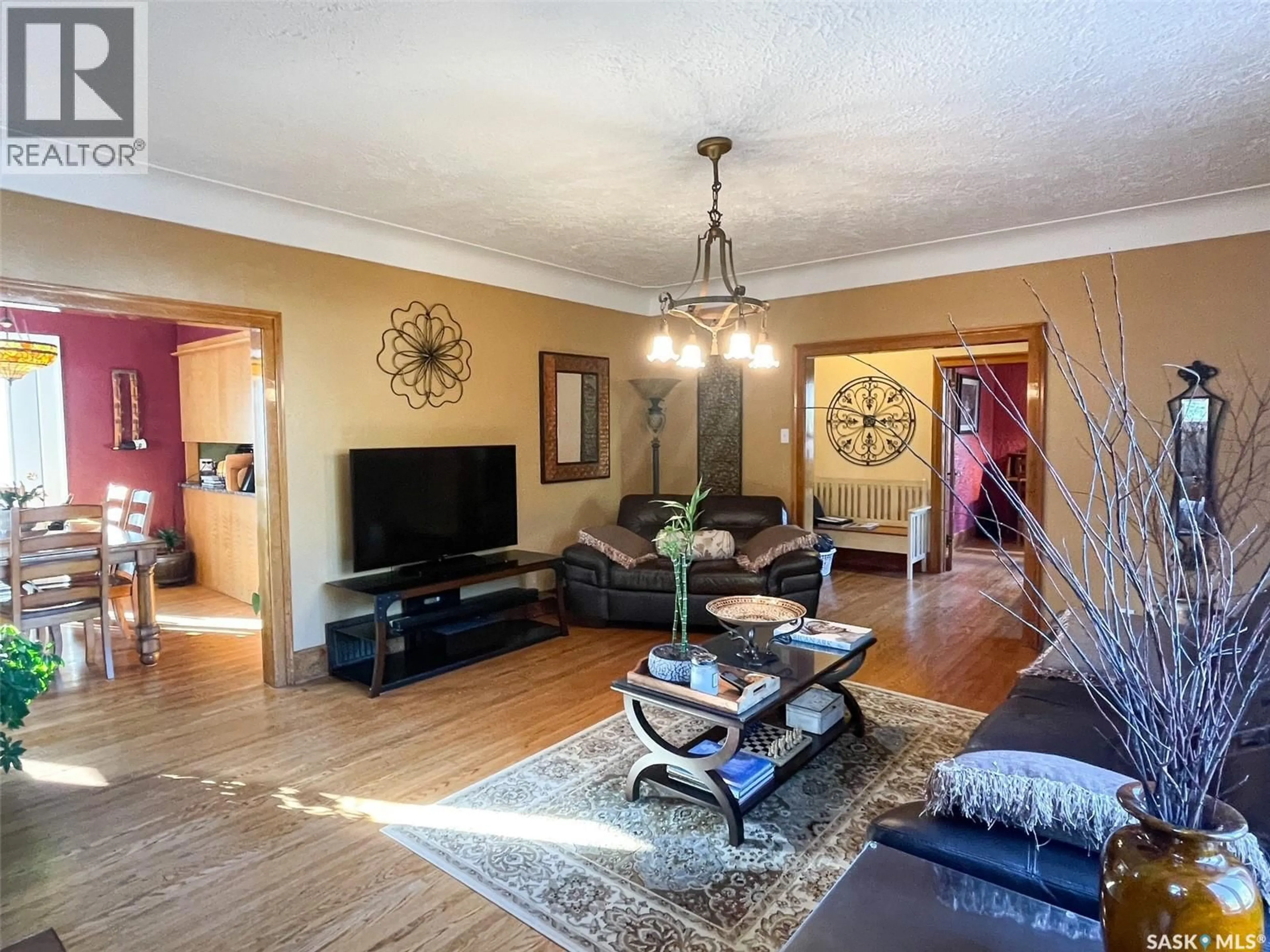 Living room with furniture, wood/laminate floor for 413 CENTRE STREET, Meadow Lake Saskatchewan S9X1E5
