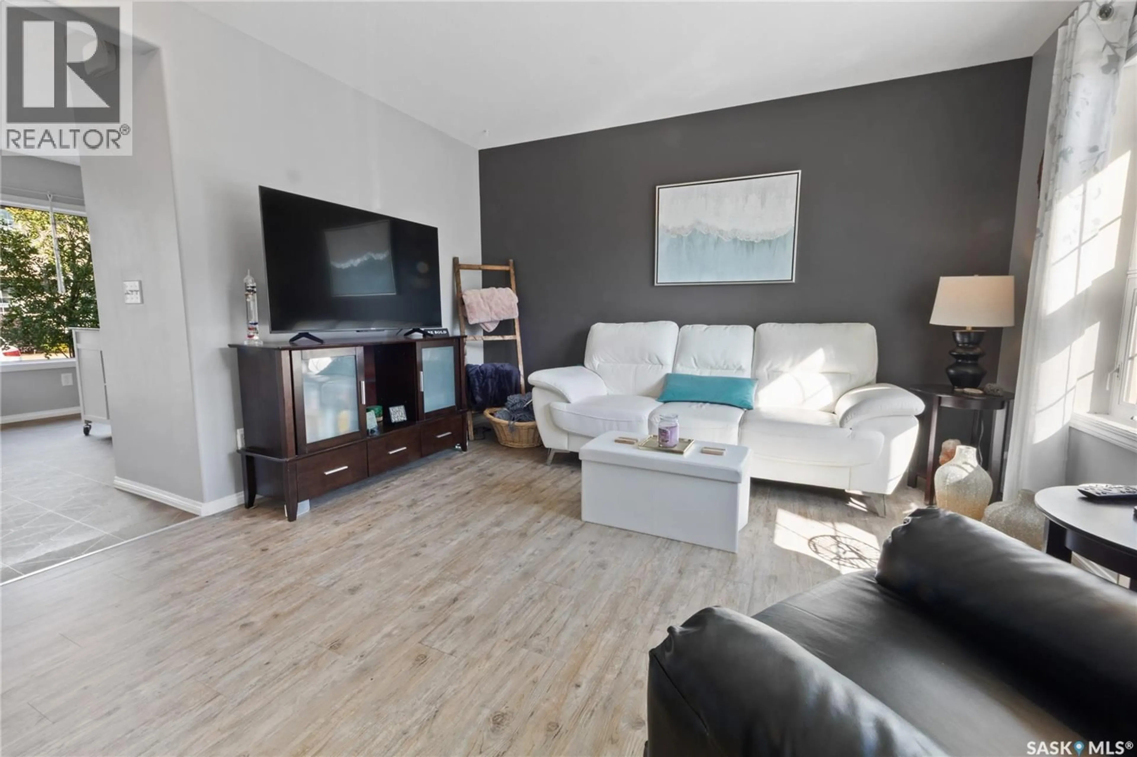 Living room with furniture, wood/laminate floor for S - 118 700 2ND AVENUE, Martensville Saskatchewan S0K2T0