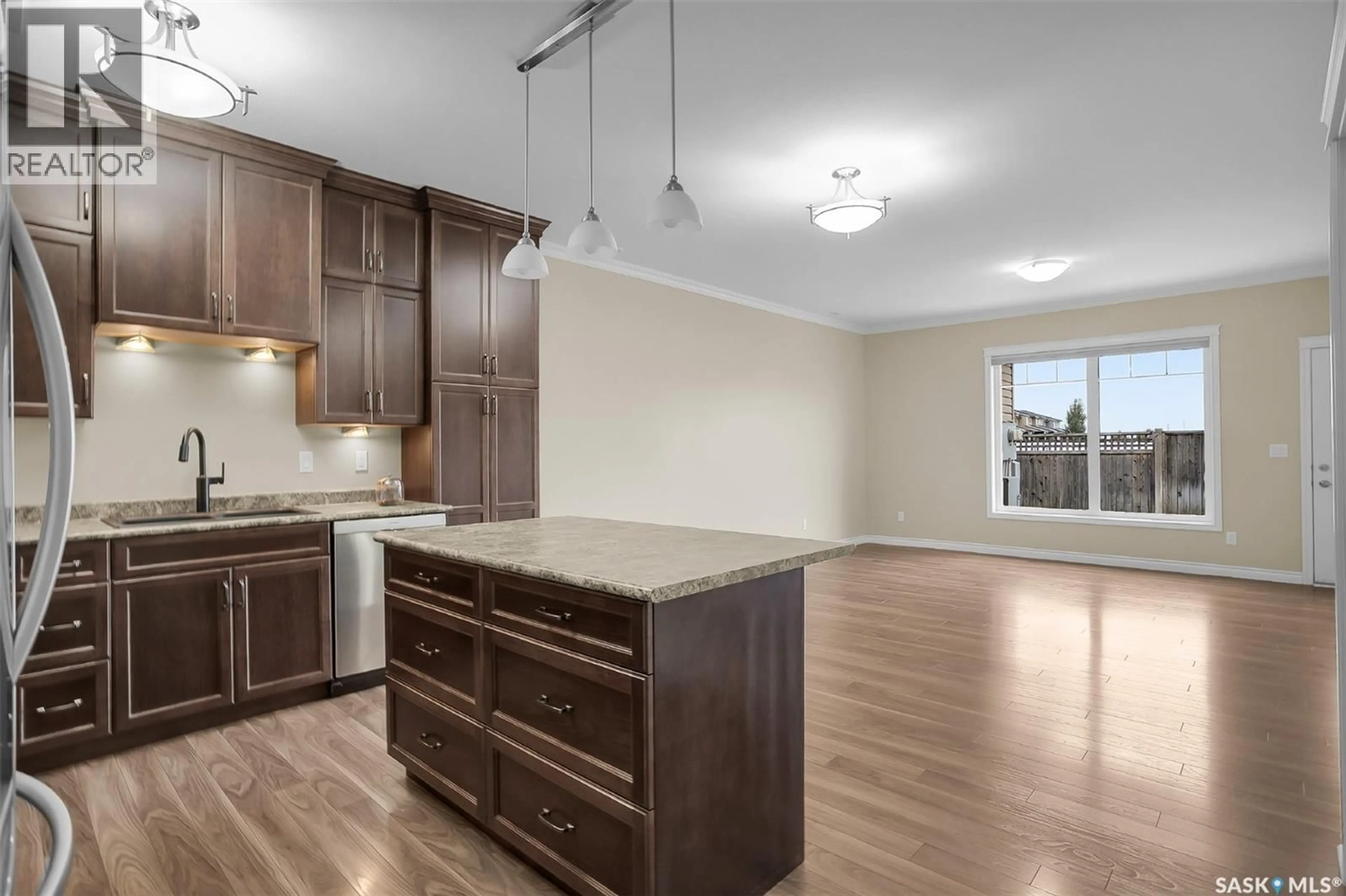 Open concept kitchen, wood/laminate floor for 34 100 BROOKLYN LANE, Warman Saskatchewan S0K0A1