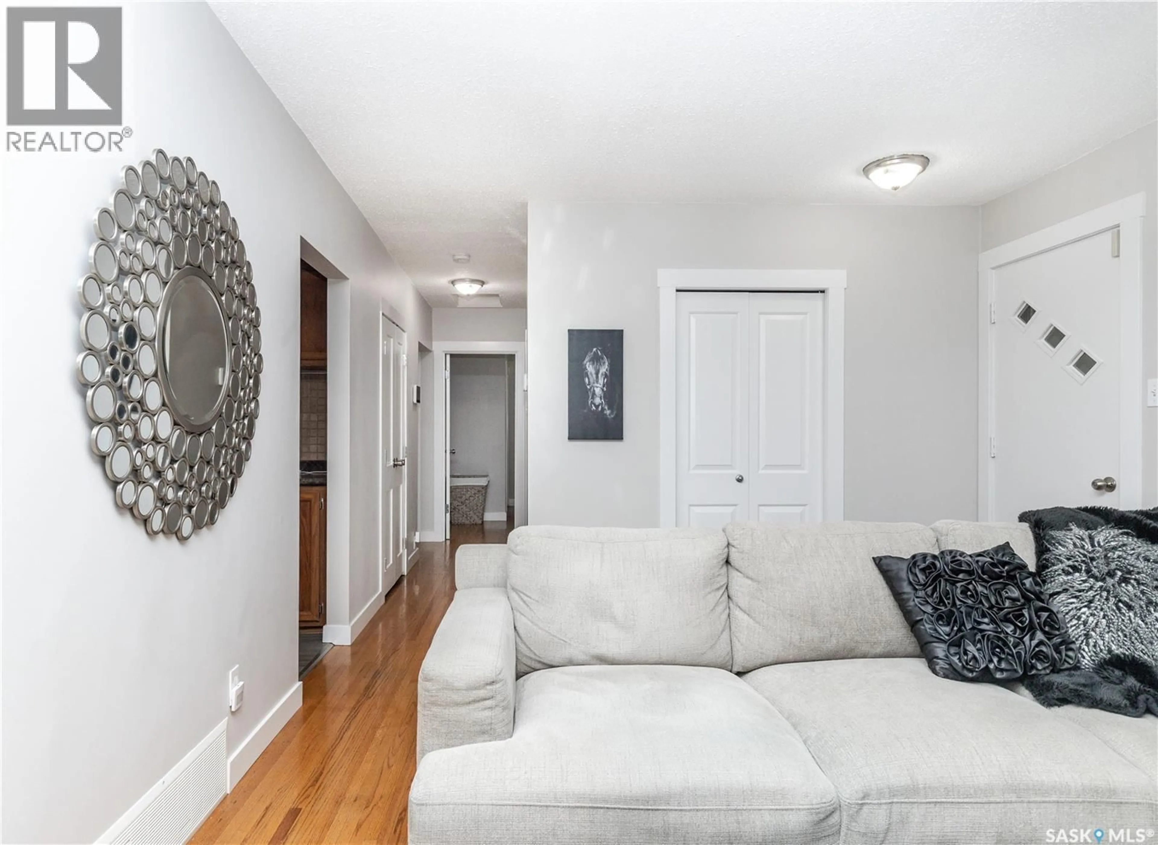 Living room with furniture, wood/laminate floor for 110 WILSON CRESCENT, Saskatoon Saskatchewan S7J2L5