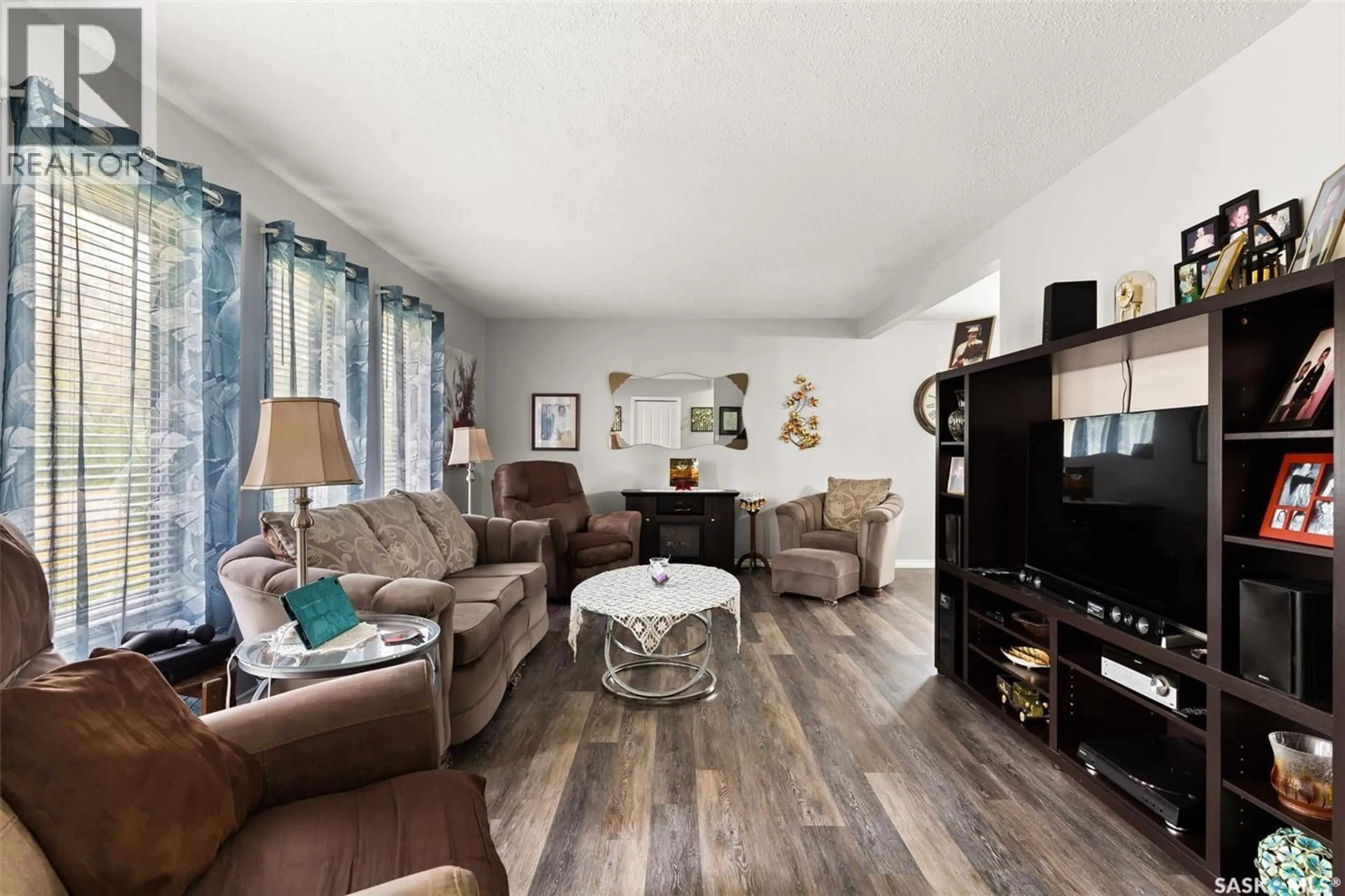 Living room with furniture, wood/laminate floor for 103 2ND STREET, Ituna Saskatchewan S0A1N0