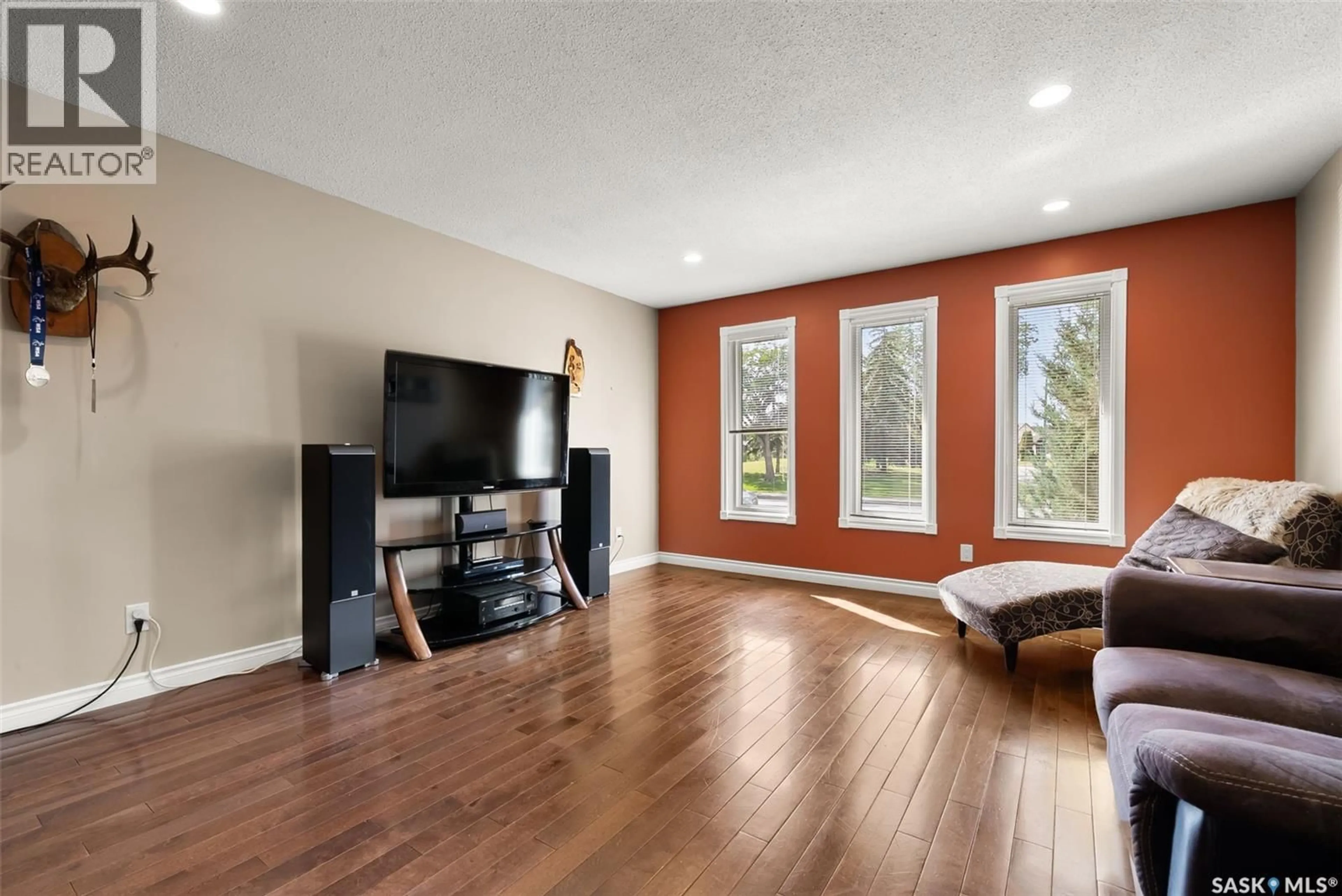 Living room with furniture, wood/laminate floor for 179 MCINNIS CRESCENT, Regina Saskatchewan S4R3E9
