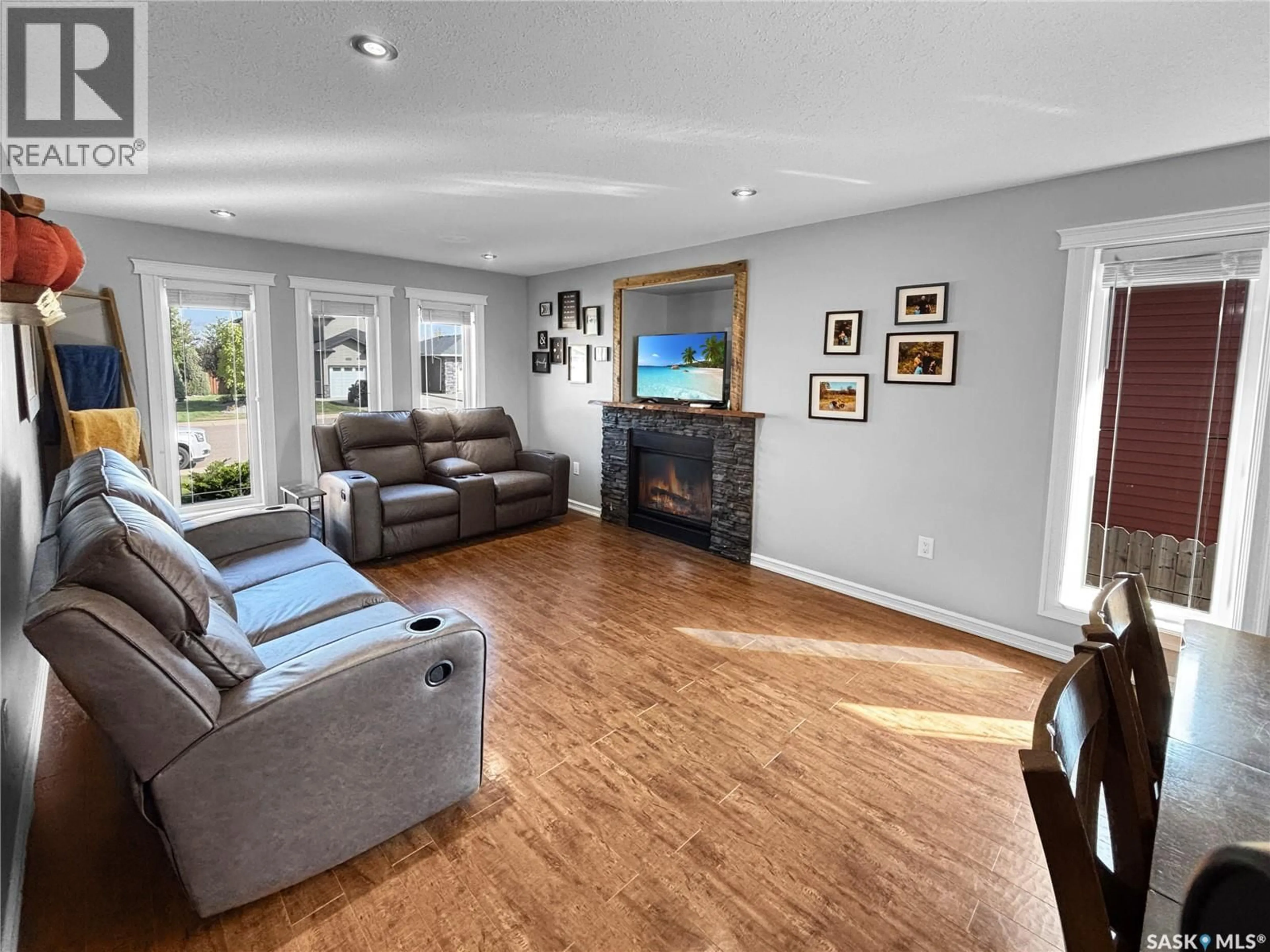 Living room with furniture, wood/laminate floor for 10320 MAHER DRIVE, North Battleford Saskatchewan S9A0J1