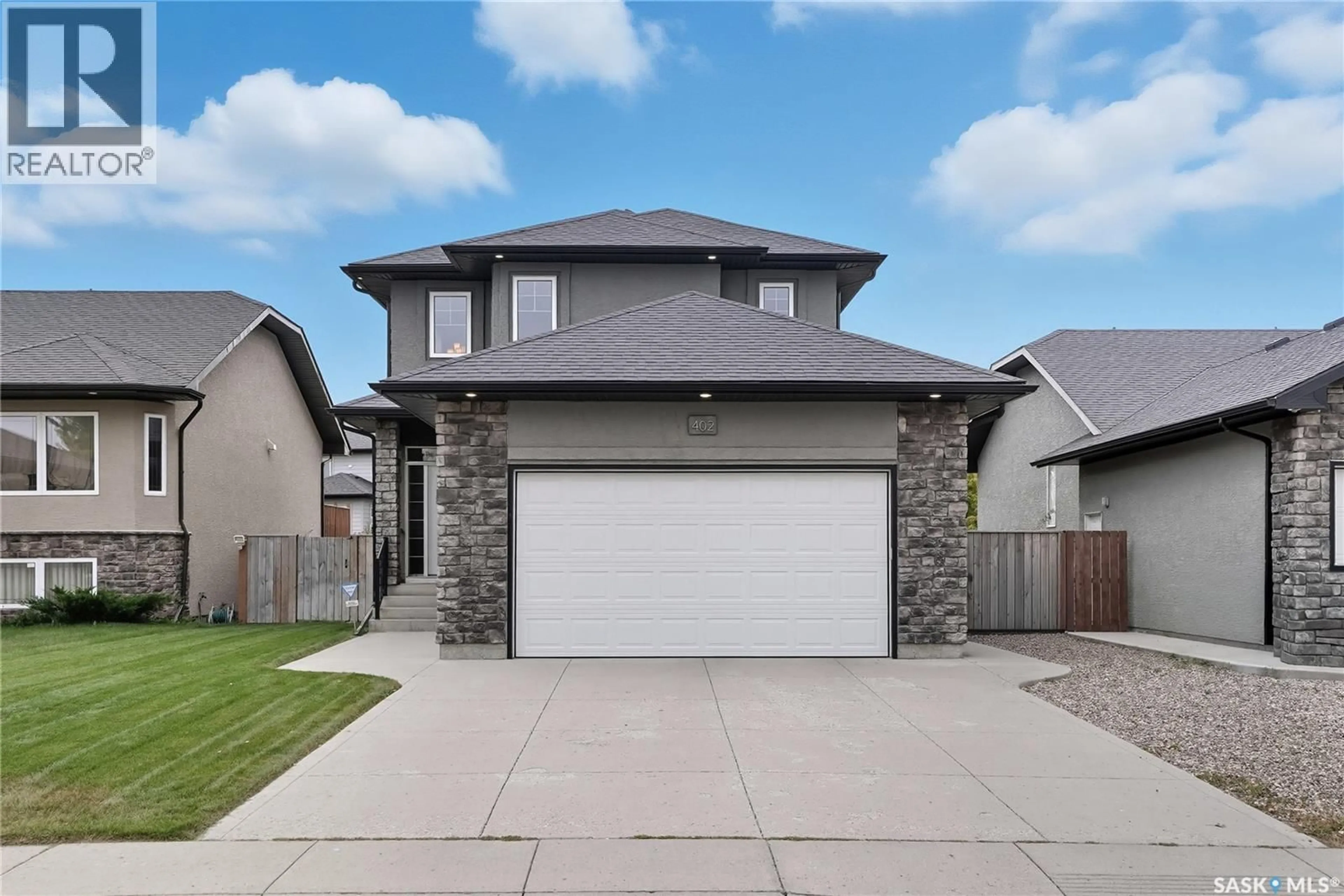 Home with brick exterior material, street for 402 LAYCOCK CRESCENT, Saskatoon Saskatchewan S7T0K2
