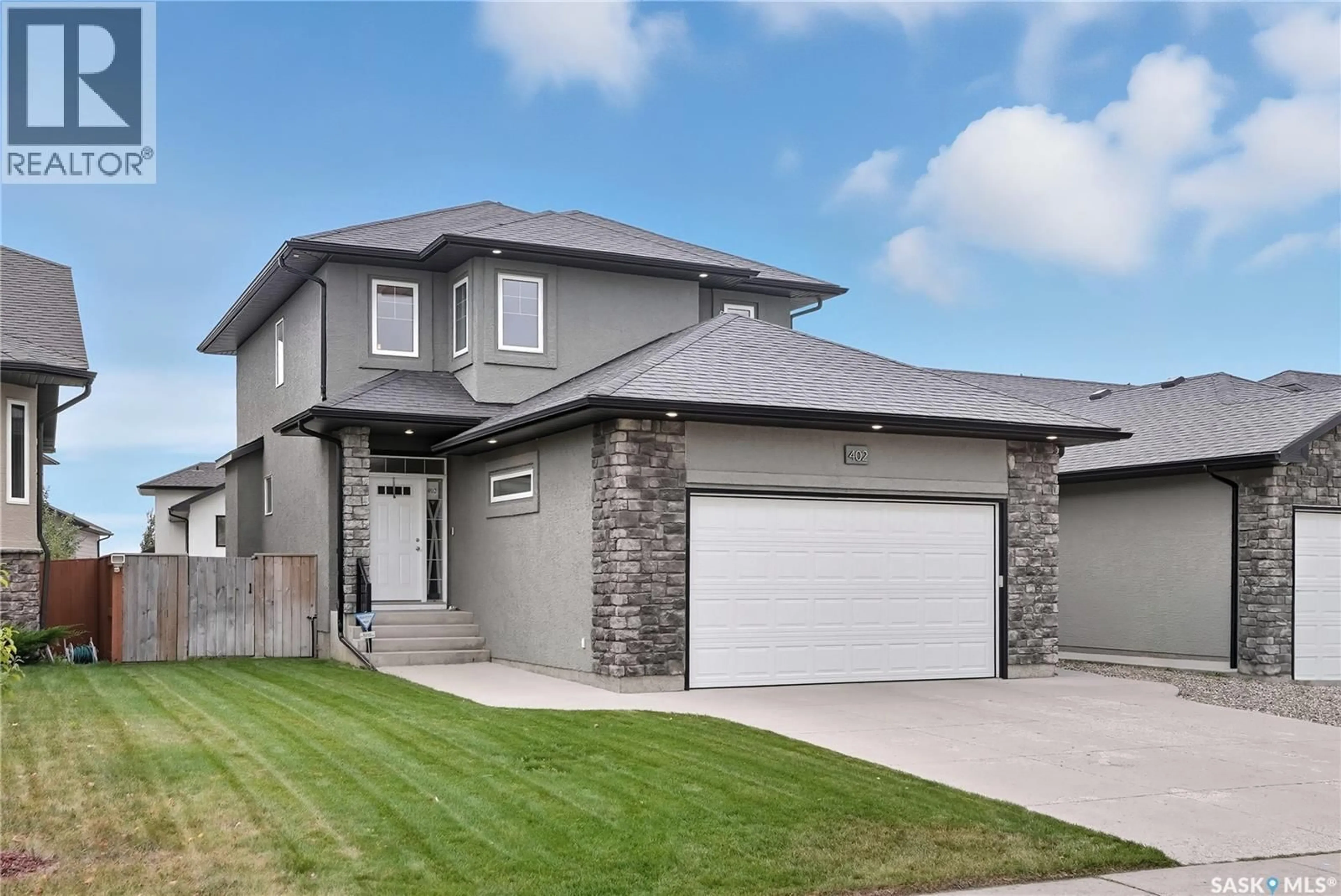 Home with brick exterior material, street for 402 LAYCOCK CRESCENT, Saskatoon Saskatchewan S7T0K2