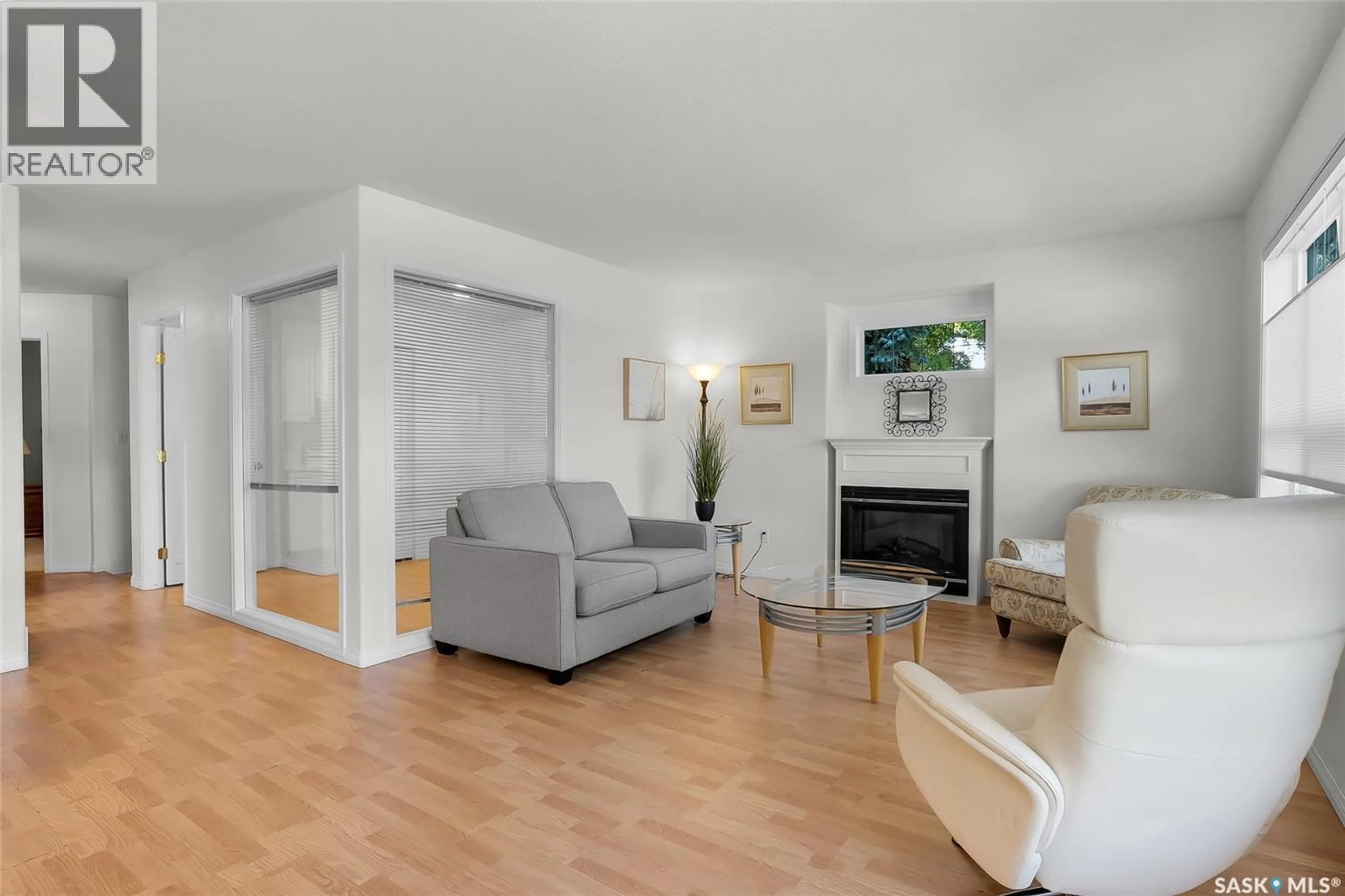 Living room with furniture, wood/laminate floor for 102 - 19 WILLOW STREET, Saskatoon Saskatchewan S7J0C2